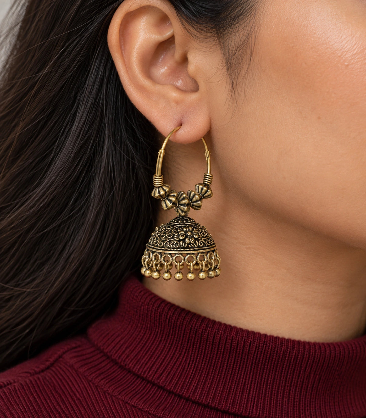 JIMIKI Beaded Hoop Floral Jhumka Earrings - Antique Gold earring worn by a model #color_antique-gold