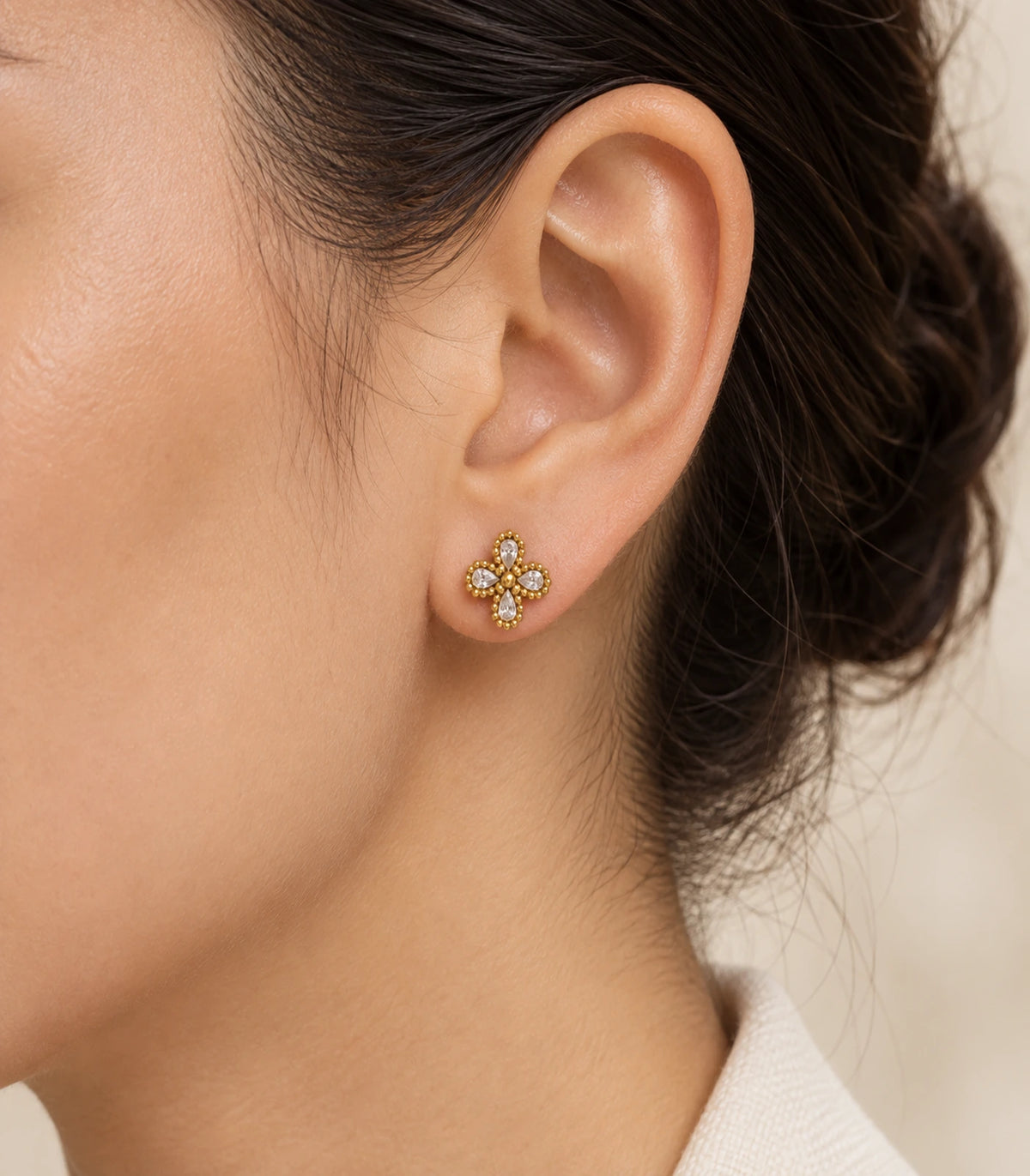 JIMIKI Antique Gold Crystal Clover Stud Earrings, single stud worn with swept-back hair and soft warm lighting #color_antique gold