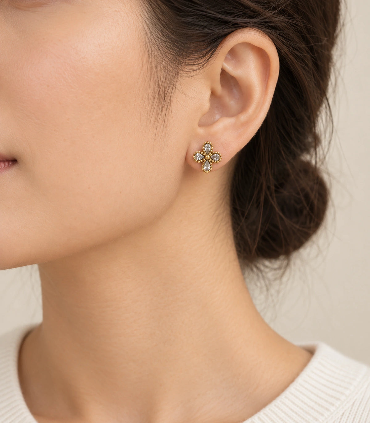 JIMIKI Antique Gold Crystal Clover Stud Earrings, single stud worn naturally with hair tucked behind the ear #color_antique gold