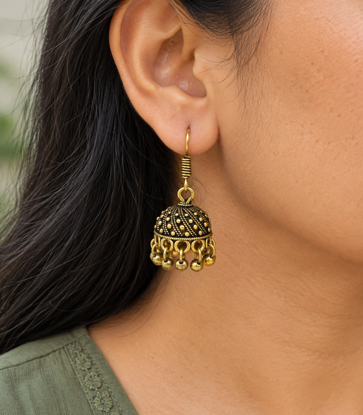 JIMIKI Antique Gold Dotted Swirl Mini Jhumka Earrings - earring worn with a clear view of the design #color_antique-gold