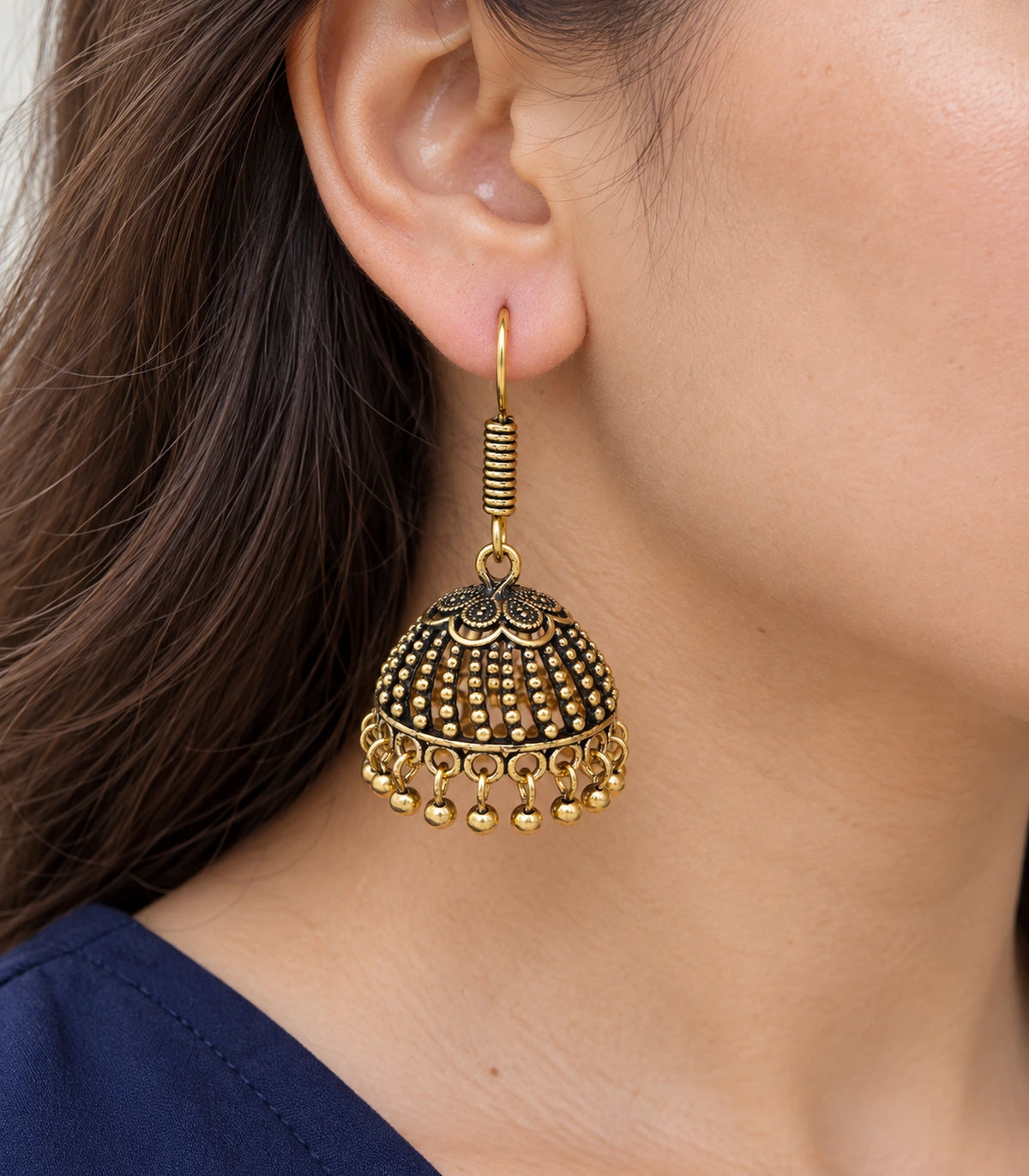JIMIKI Antique Gold Floral Cap Beaded Dome Jhumka Earrings - earring worn with a clear view of the design #color_antique-gold