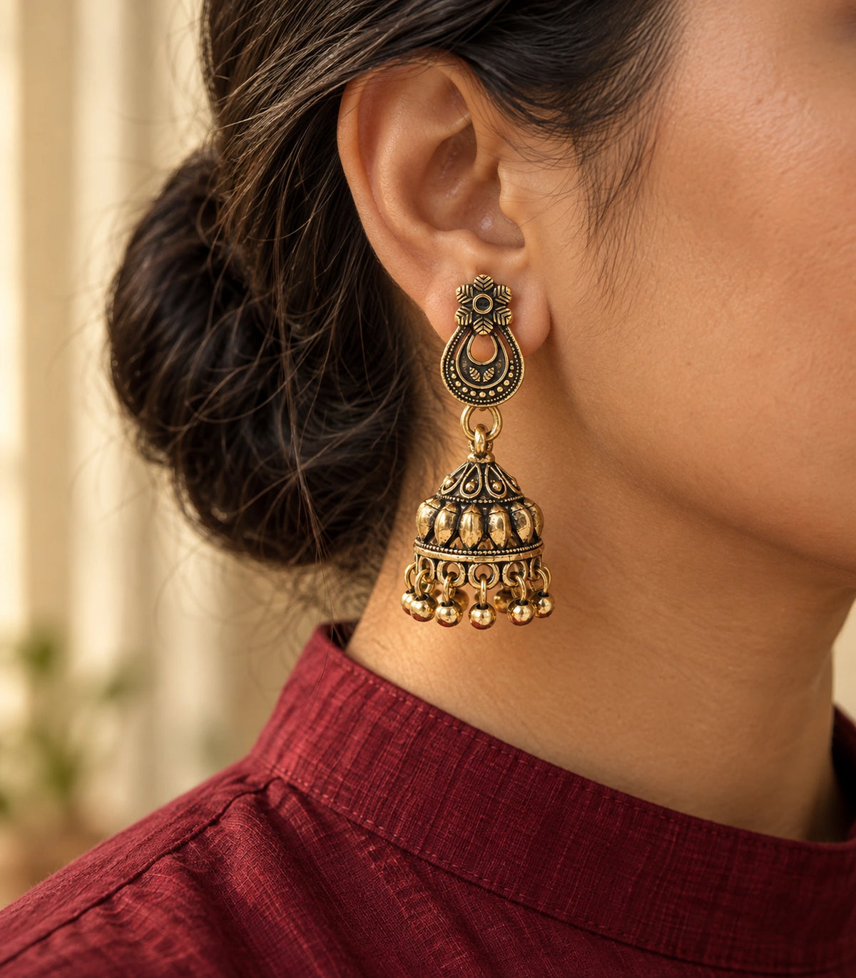 JIMIKI Antique Gold Floral Teardrop Leaf Jhumka Earrings in Antique Gold - editorial worn view #color_antique-gold
