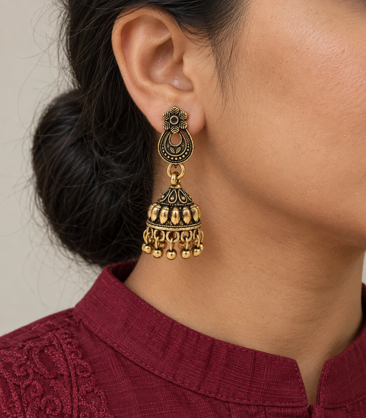 JIMIKI Antique Gold Floral Teardrop Leaf Jhumka Earrings in Antique Gold - worn styling view #color_antique-gold