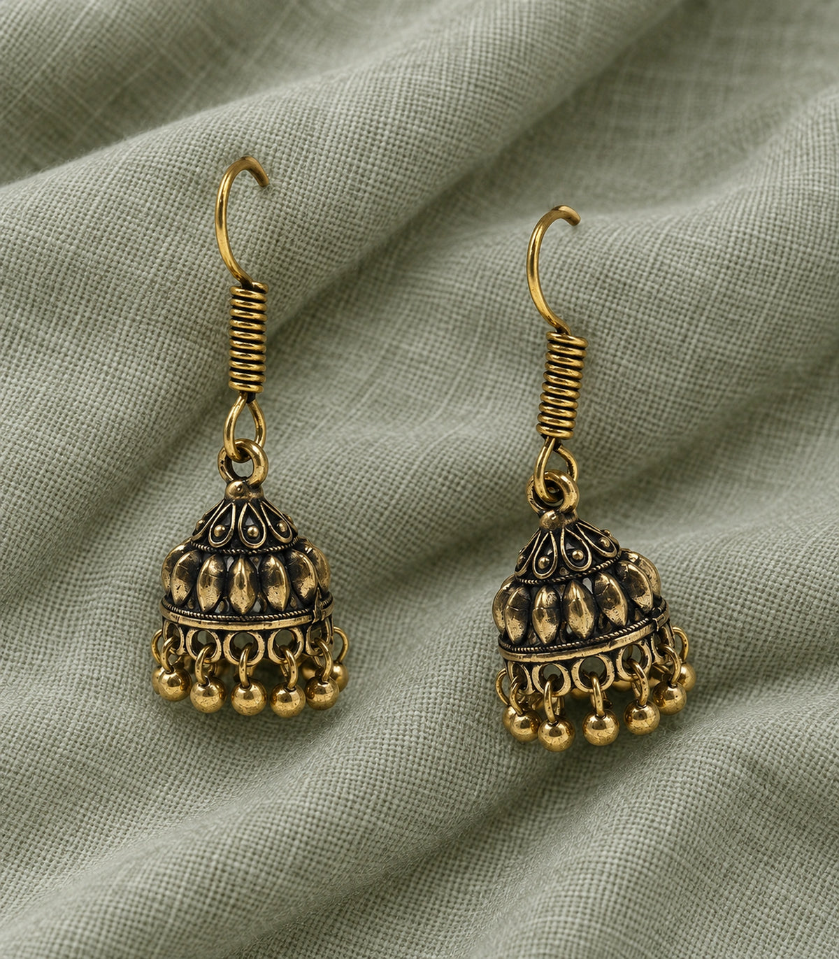 JIMIKI Leaf Dome Hook Jhumka Earrings in Antique Gold - editorial flatlay #color_antique-gold
