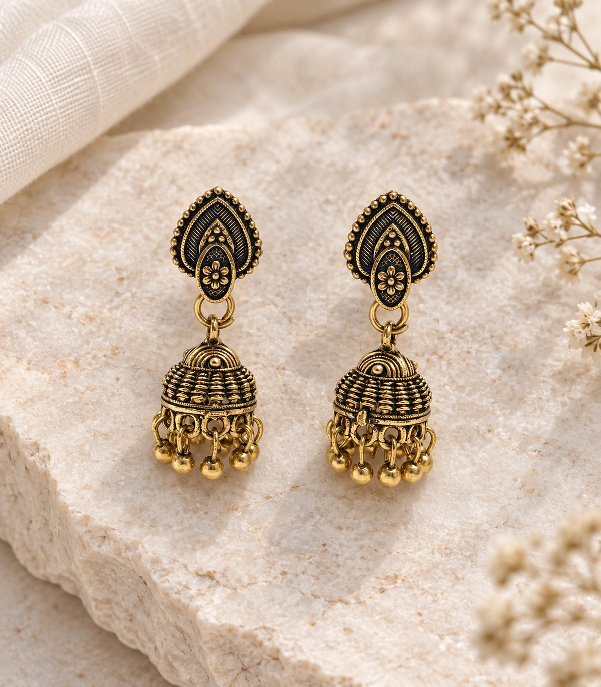JIMIKI Leaf Stud Beaded Jhumka Earrings - Antique Gold styled flatlay of the matching earrings #color_antique-gold