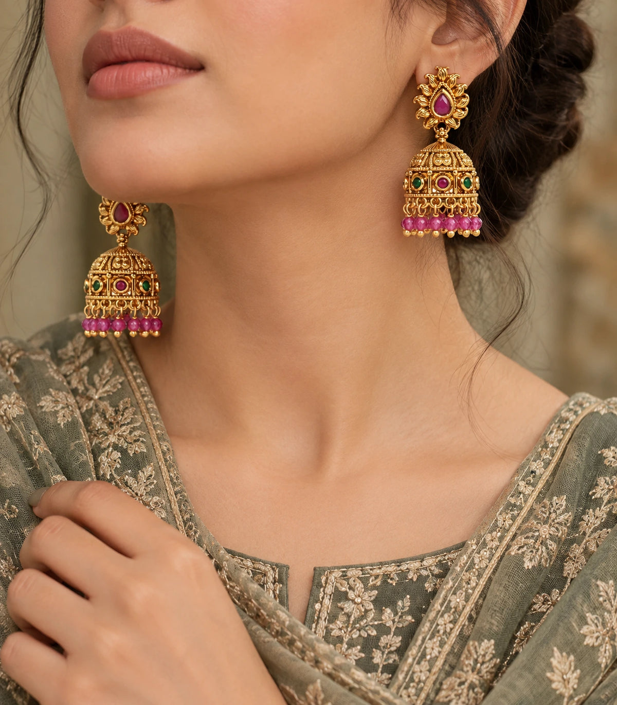 Antique gold-tone magenta and green flame jhumka earrings styled with a green outfit