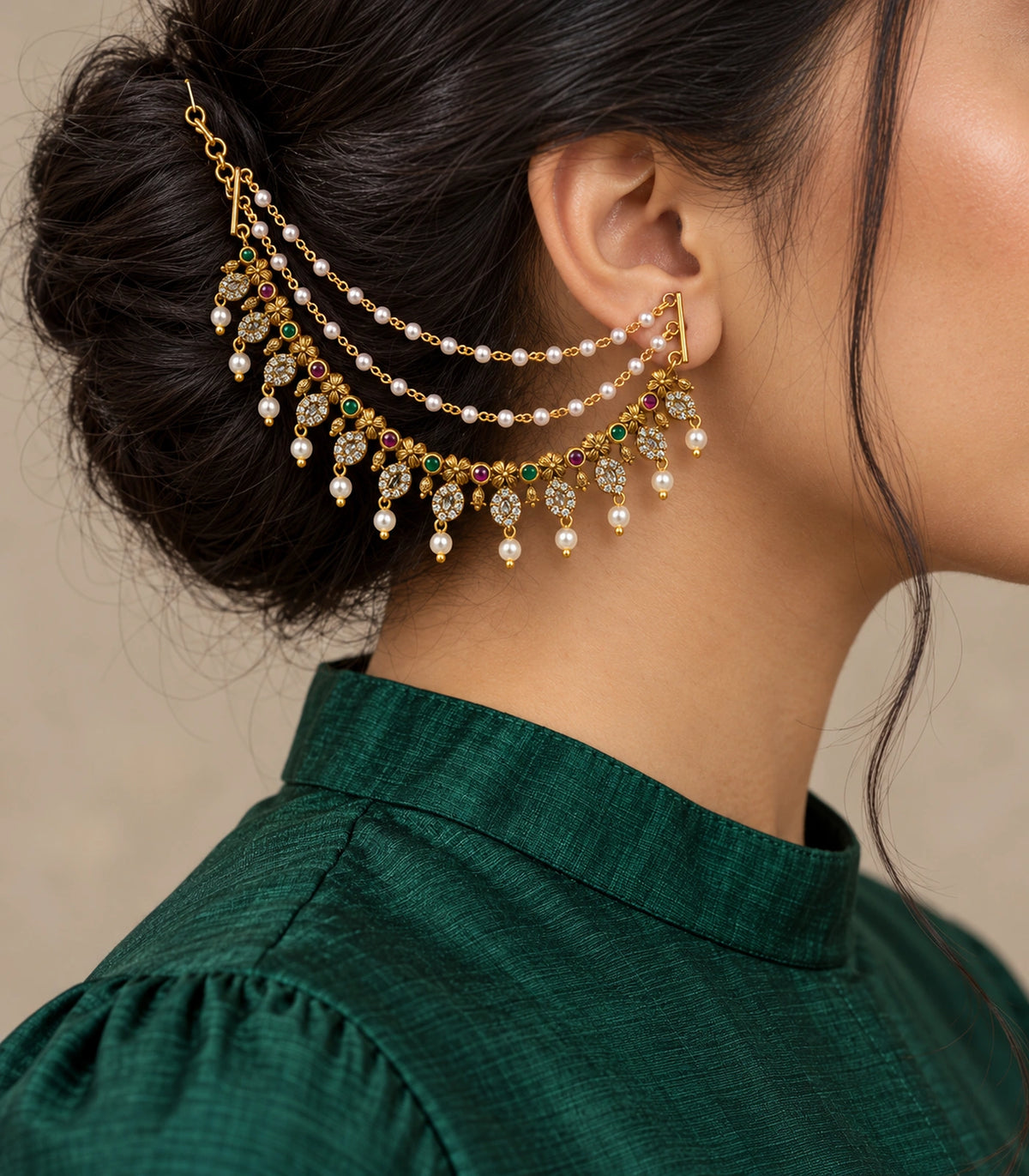 Antique gold tone flower oval pearl ear chain worn with a modest emerald silk outfit