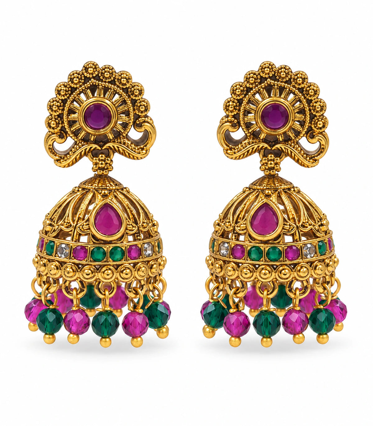 Matching pair of antique gold tone peacock jhumka earrings with magenta and green accents on a white background