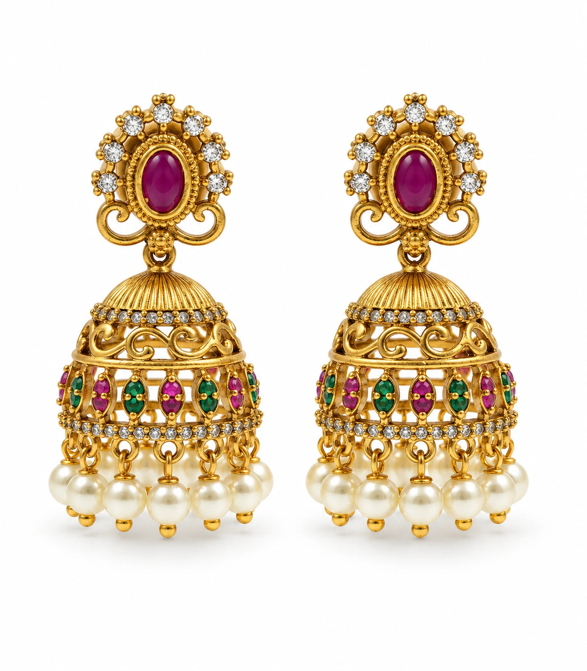 Matching pair of antique gold-tone magenta and green crystal pearl jhumka earrings on white
