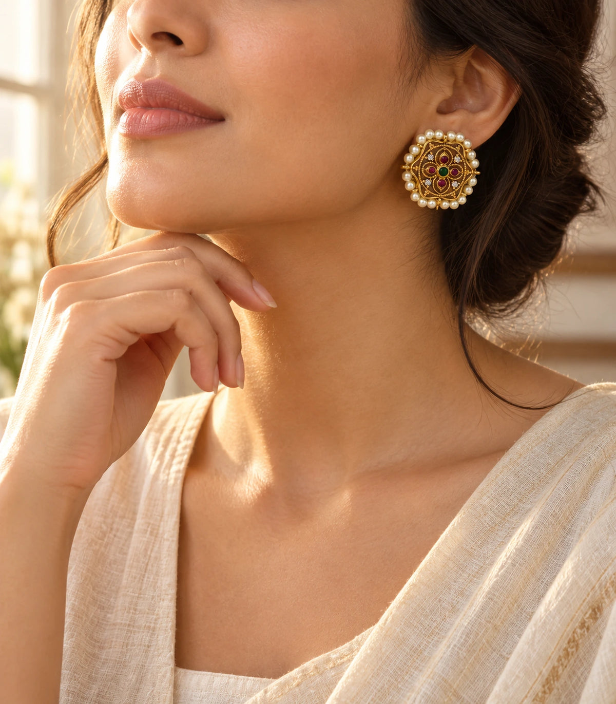 Single scalloped gold-tone stud worn in a three-quarter view with magenta stones, green centre and cream pearl border
