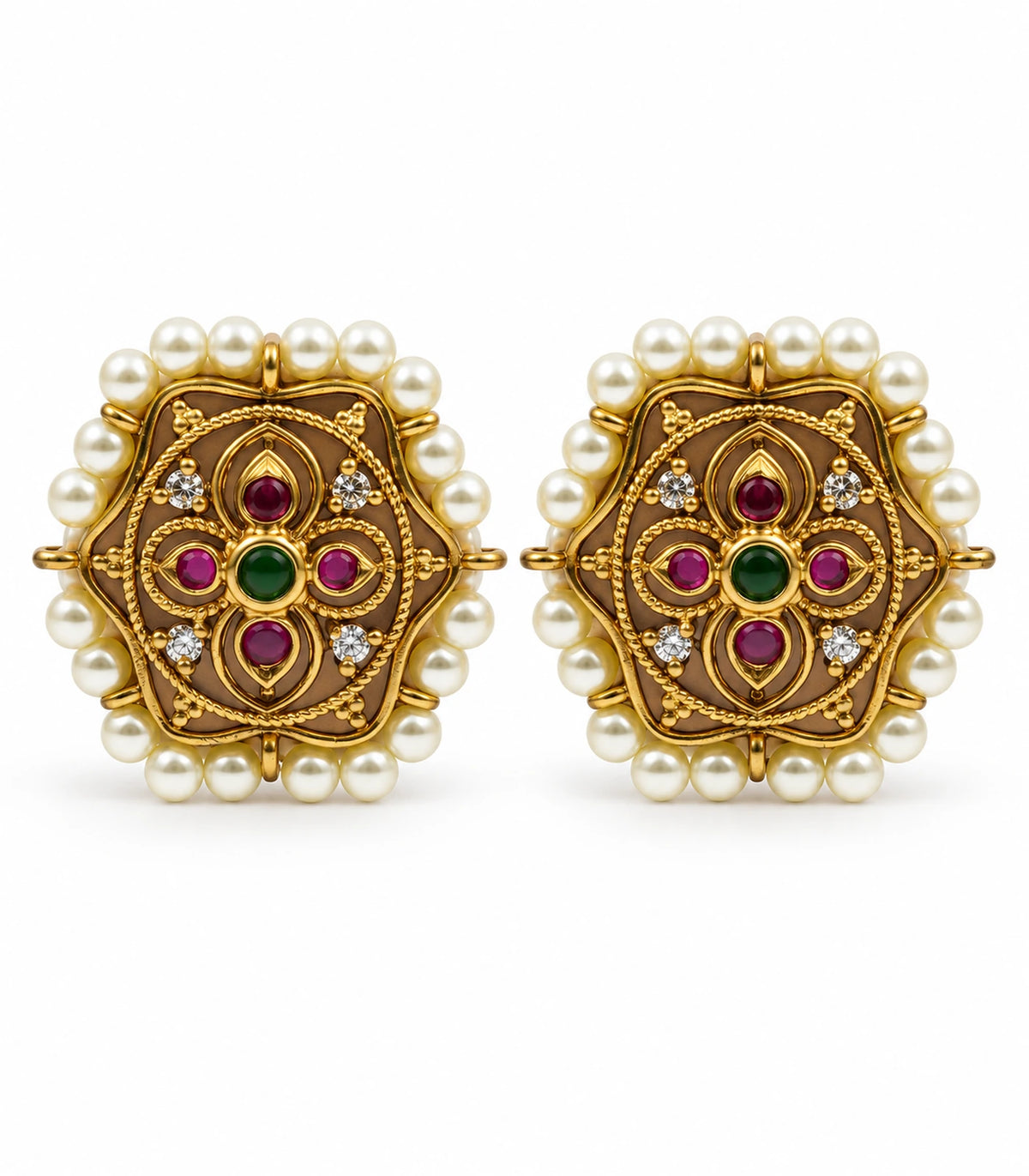 Pair of antique gold-tone scalloped stud earrings with magenta stones, green centres and cream pearl borders on white