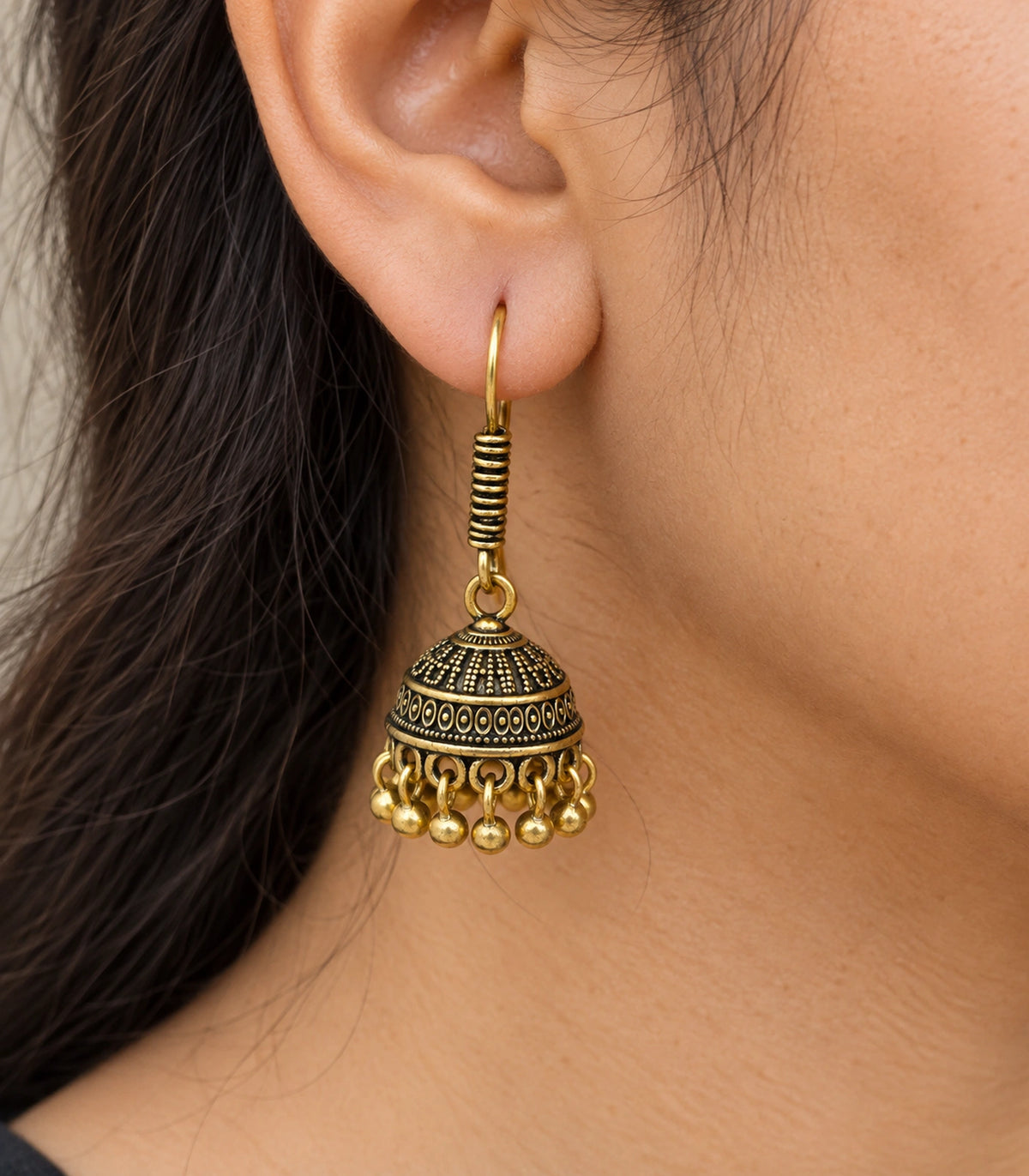 JIMIKI Antique Gold Oval Band Jhumka Earrings - close-up of the earring worn #color_antique-gold