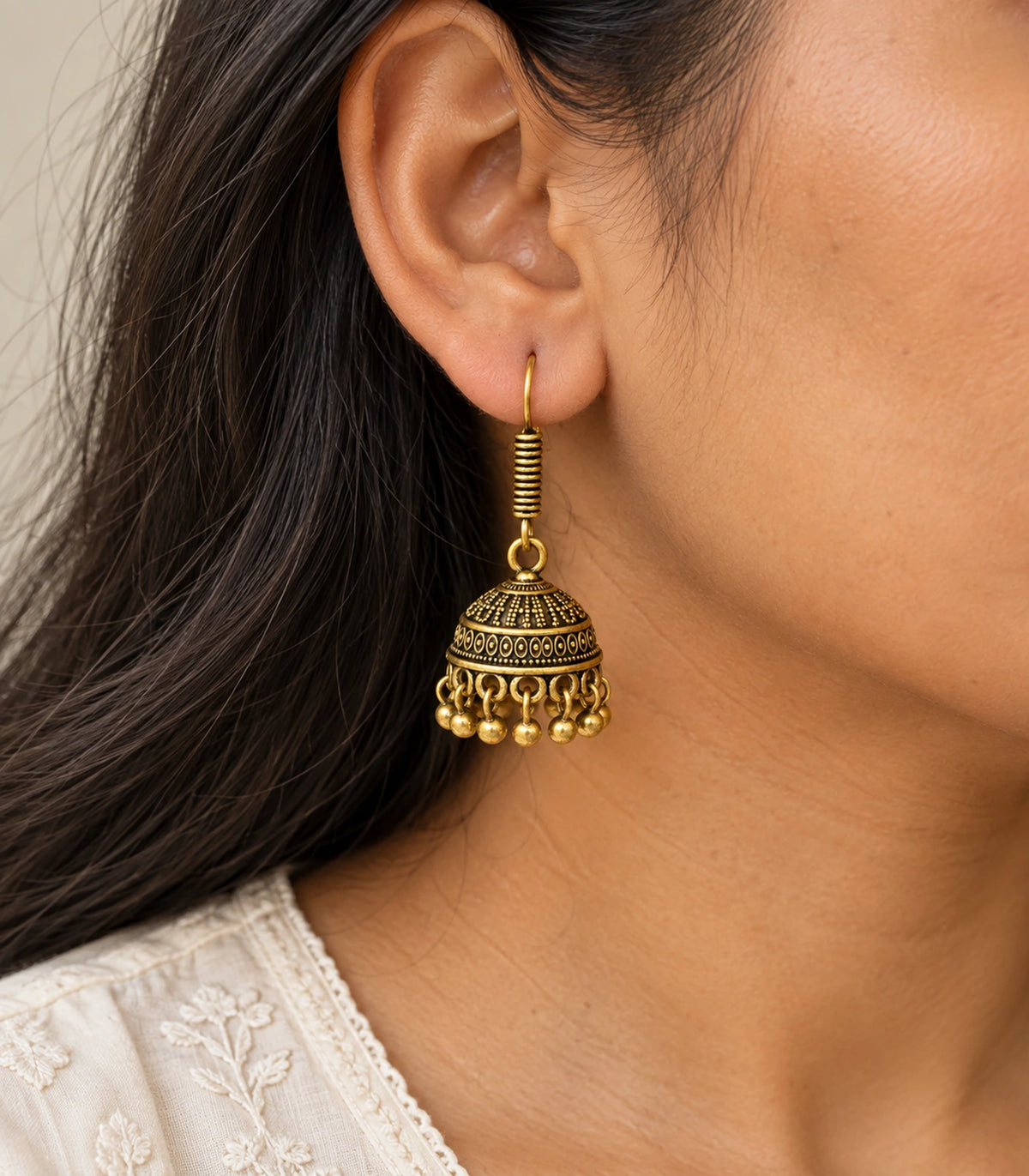 JIMIKI Antique Gold Oval Band Jhumka Earrings - earring worn with a clear view of the design #color_antique-gold