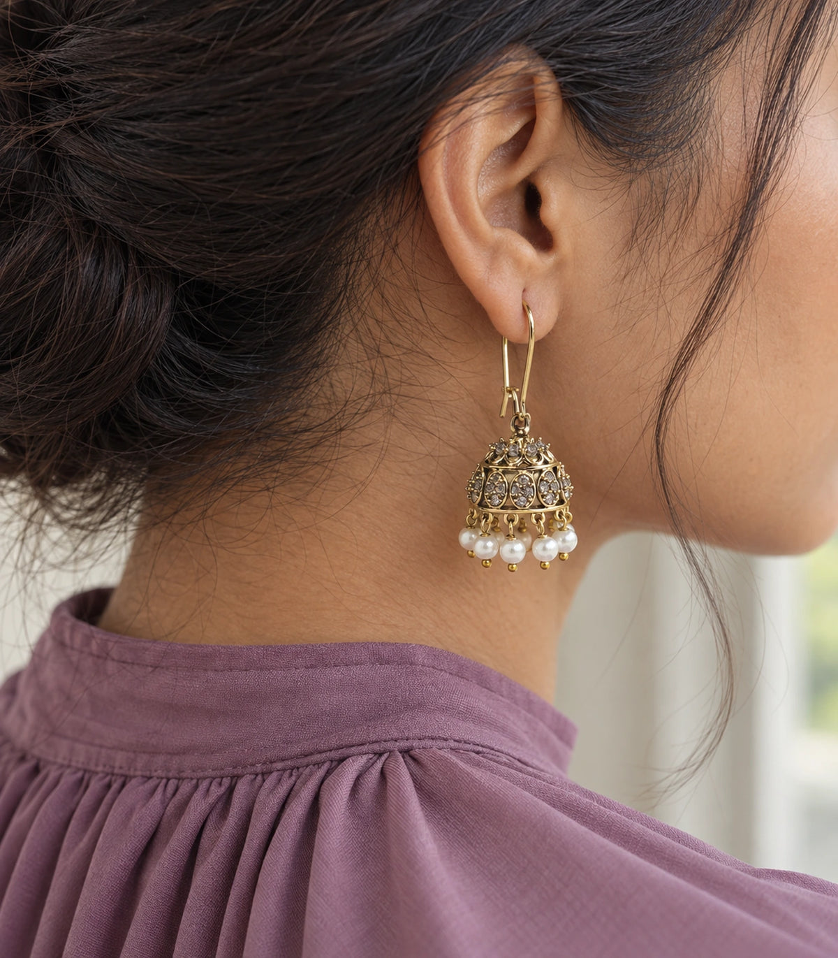 JIMIKI Antique Gold Oval Crystal Pearl Kidney Wire Jhumka Earrings - Editorial worn view #color_antique-gold