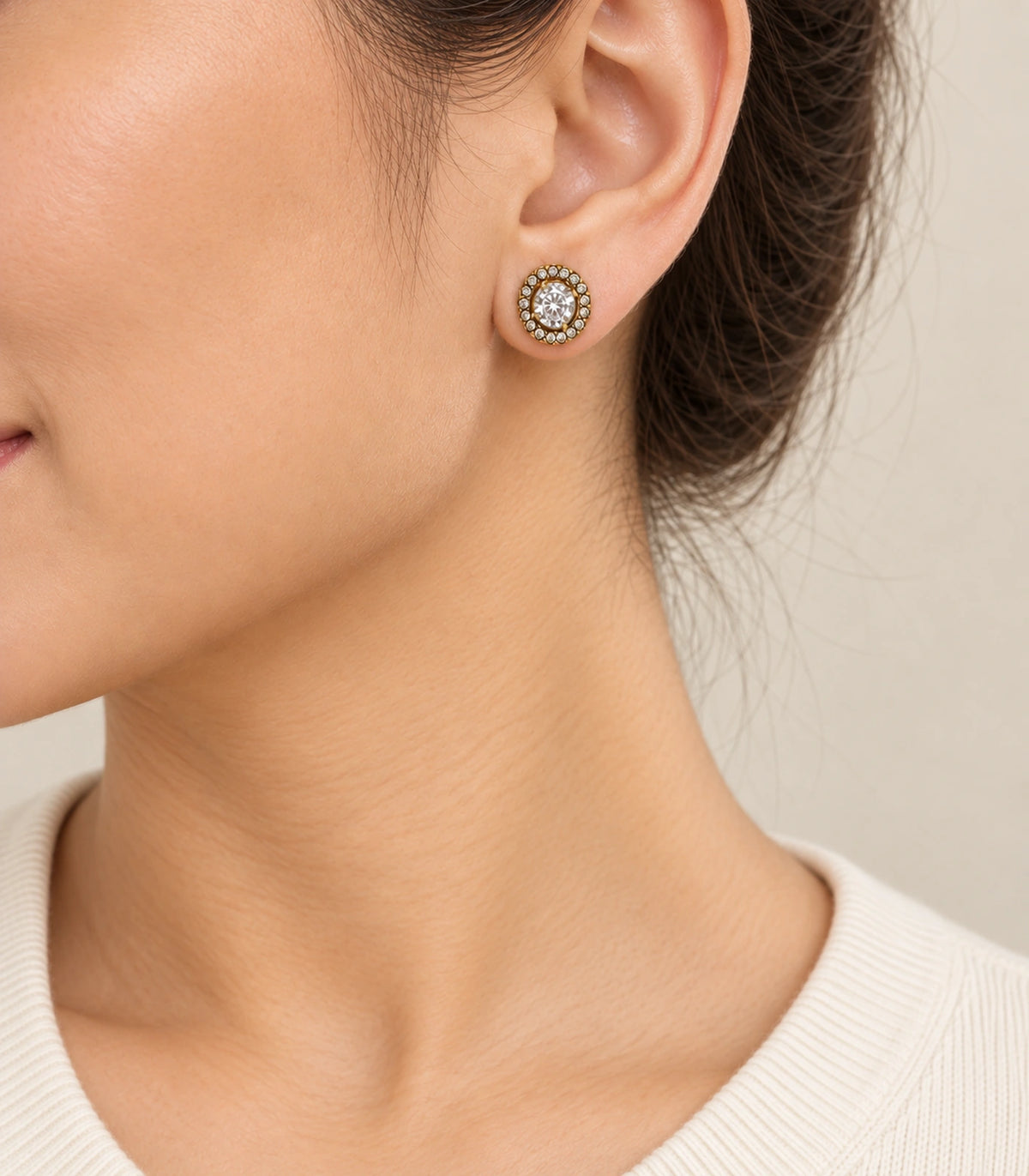 JIMIKI Antique Gold Round Crystal Halo Stud Earrings, single stud worn naturally with hair tucked behind the ear #color_antique gold