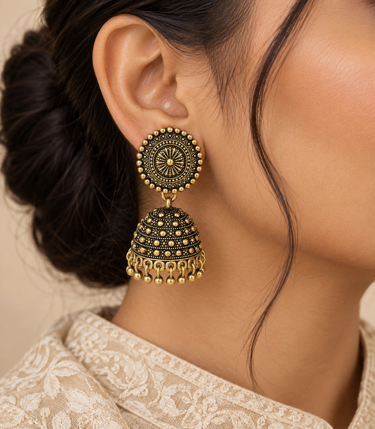 JIMIKI Antique Gold Sunburst Medallion Jhumka Earrings - Earring worn with a cream embroidered outfit #color_antique-gold