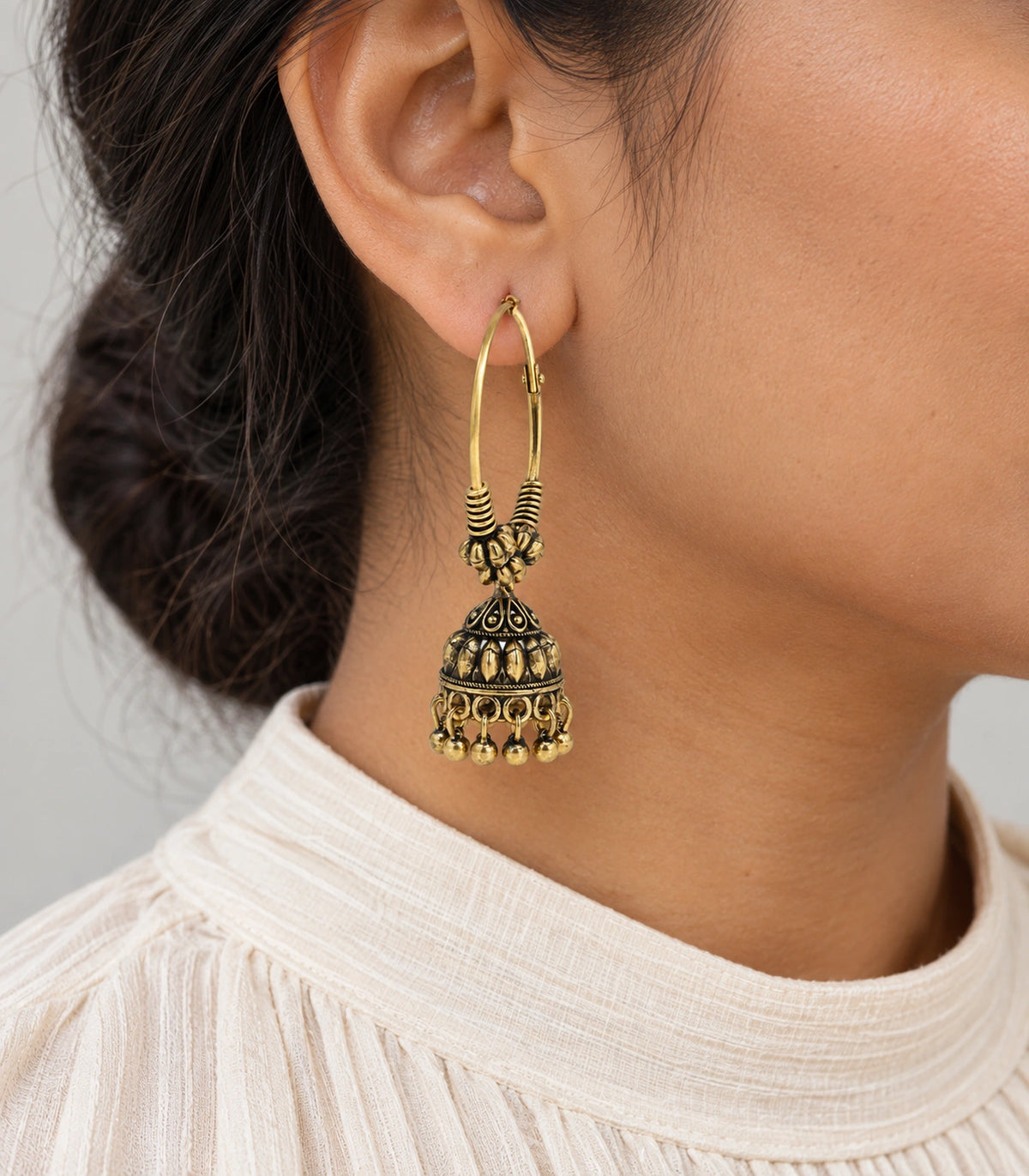 JIMIKI Antique Gold Three Bead Hoop Leaf Jhumka Earrings in Antique Gold - worn styling view #color_antique-gold