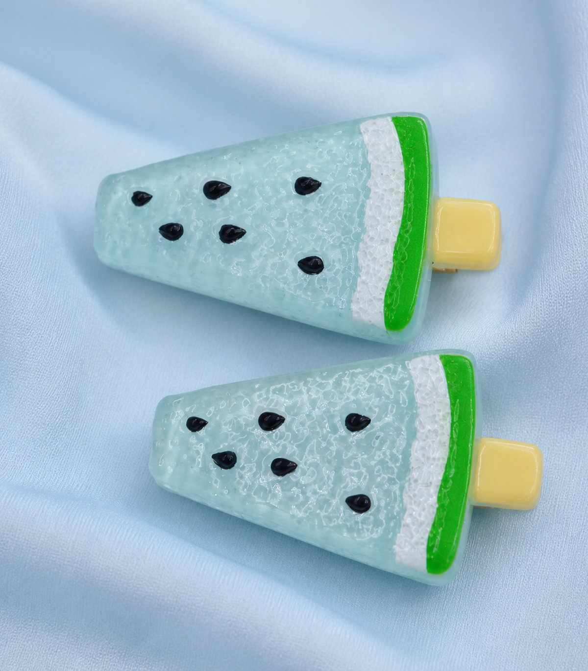 Aqua Watermelon Barrette Pair editorial flat lay