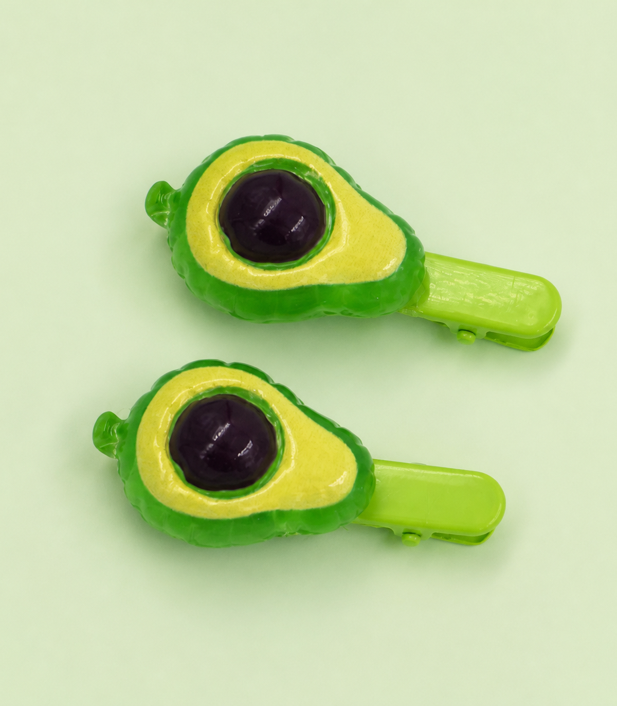 JIMIKI Raised Avocado Green Clip Pair in Green / Dark Brown, editorial flat lay