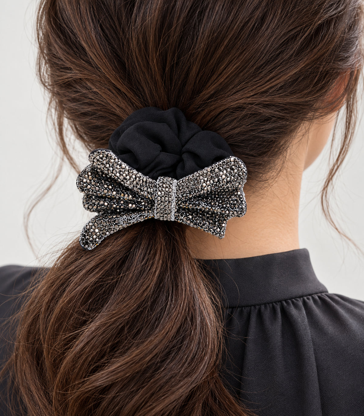 Close view of the black gathered scrunchie and layered bow in hair