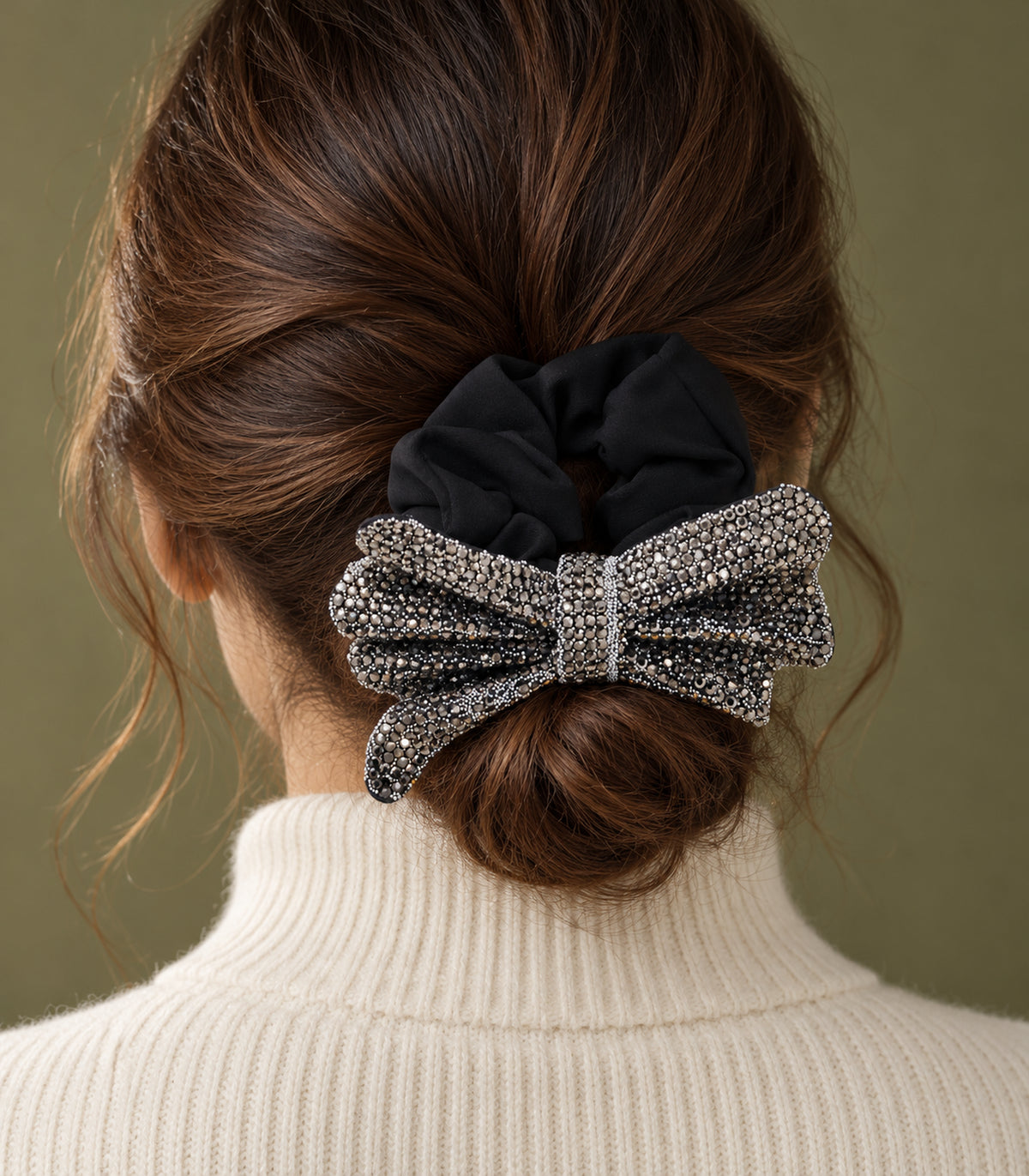 Black crystal-like bow scrunchie worn on a low bun