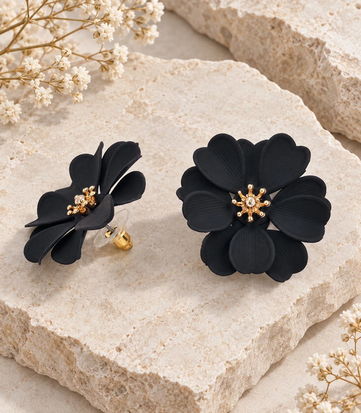 JIMIKI Black Layered Daisy Stud Earrings - pair in styled flatlay #color_black