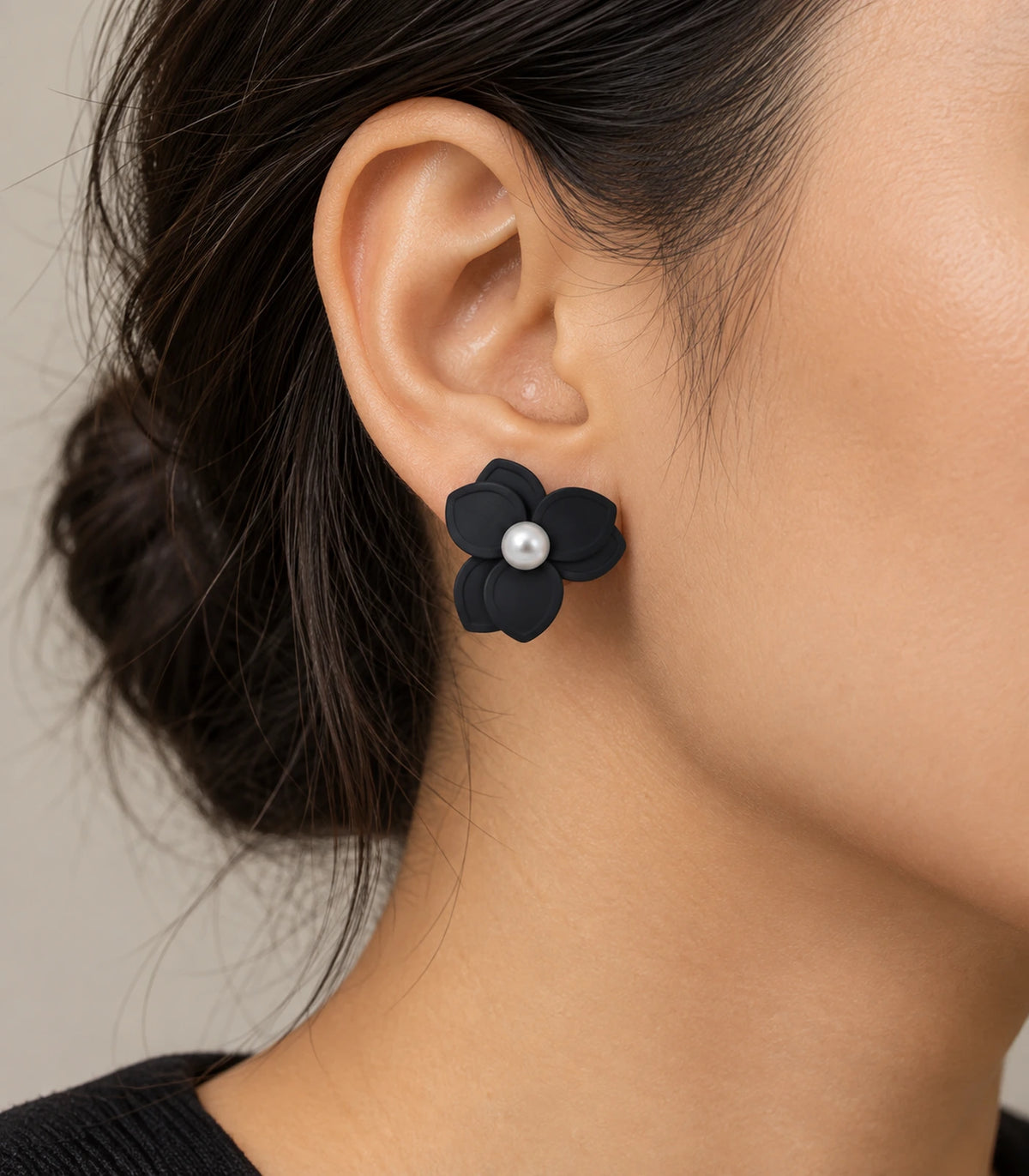 JIMIKI Black Triple Petal Pearl Flower Stud Earrings - earring worn on model #color_black