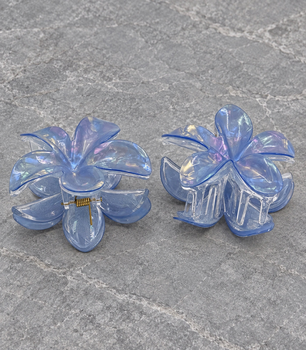 JIMIKI Iridescent Five Petal Flower Hair Claw Clips in Blue, editorial flat lay #color_blue