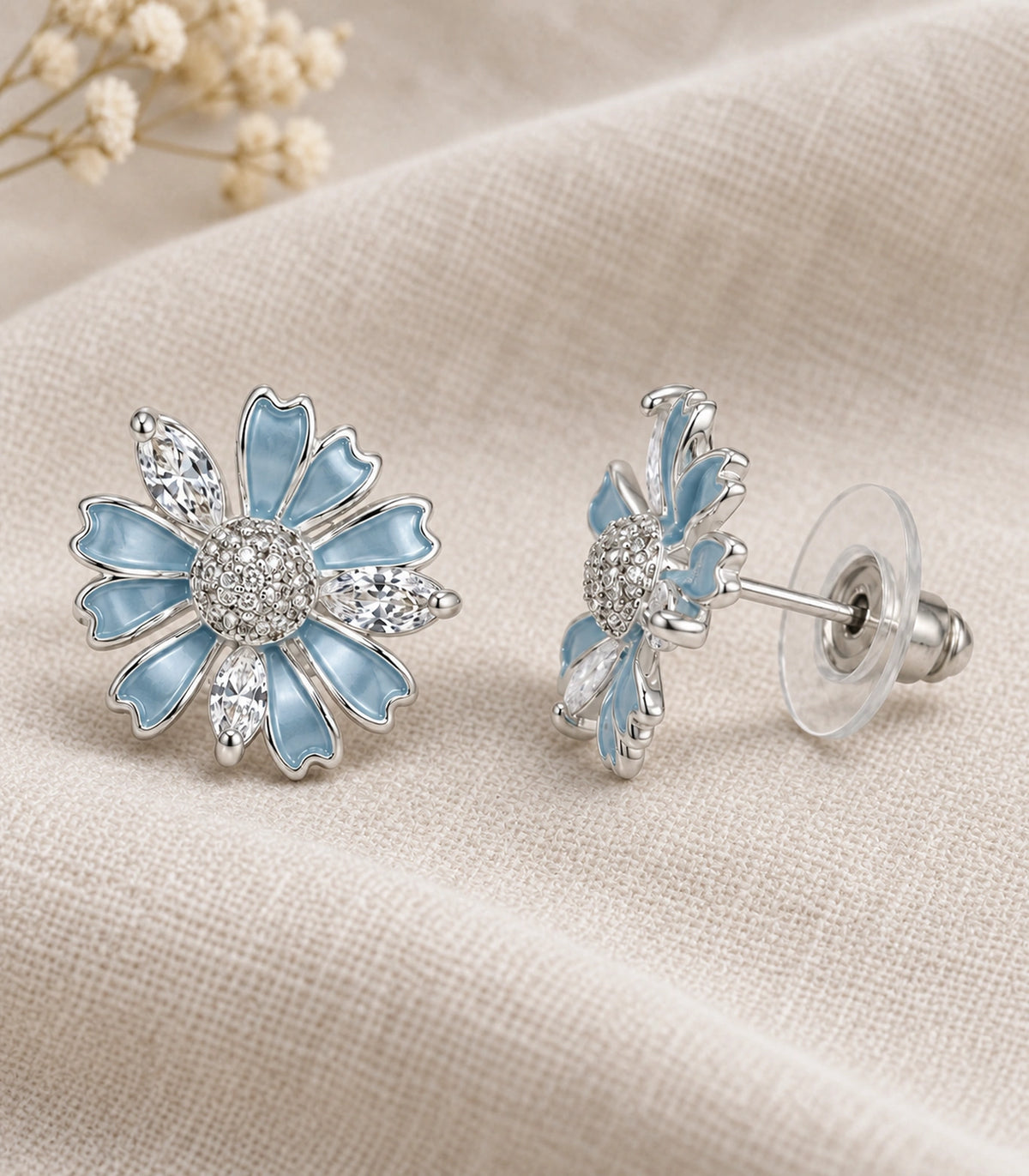 JIMIKI Petal Crystal Flower Stud Earring Pair in Blue / silver tone, editorial flat lay #color_blue / silver tone