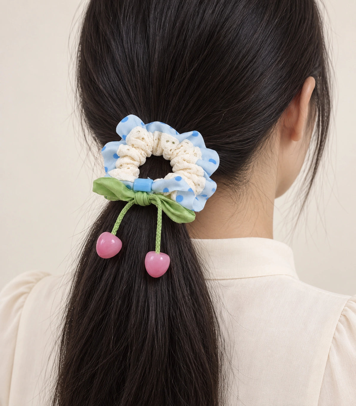 JIMIKI Polka Dot Lace Scrunchie With Cherry Charms in Blue, model wearing view #color_blue