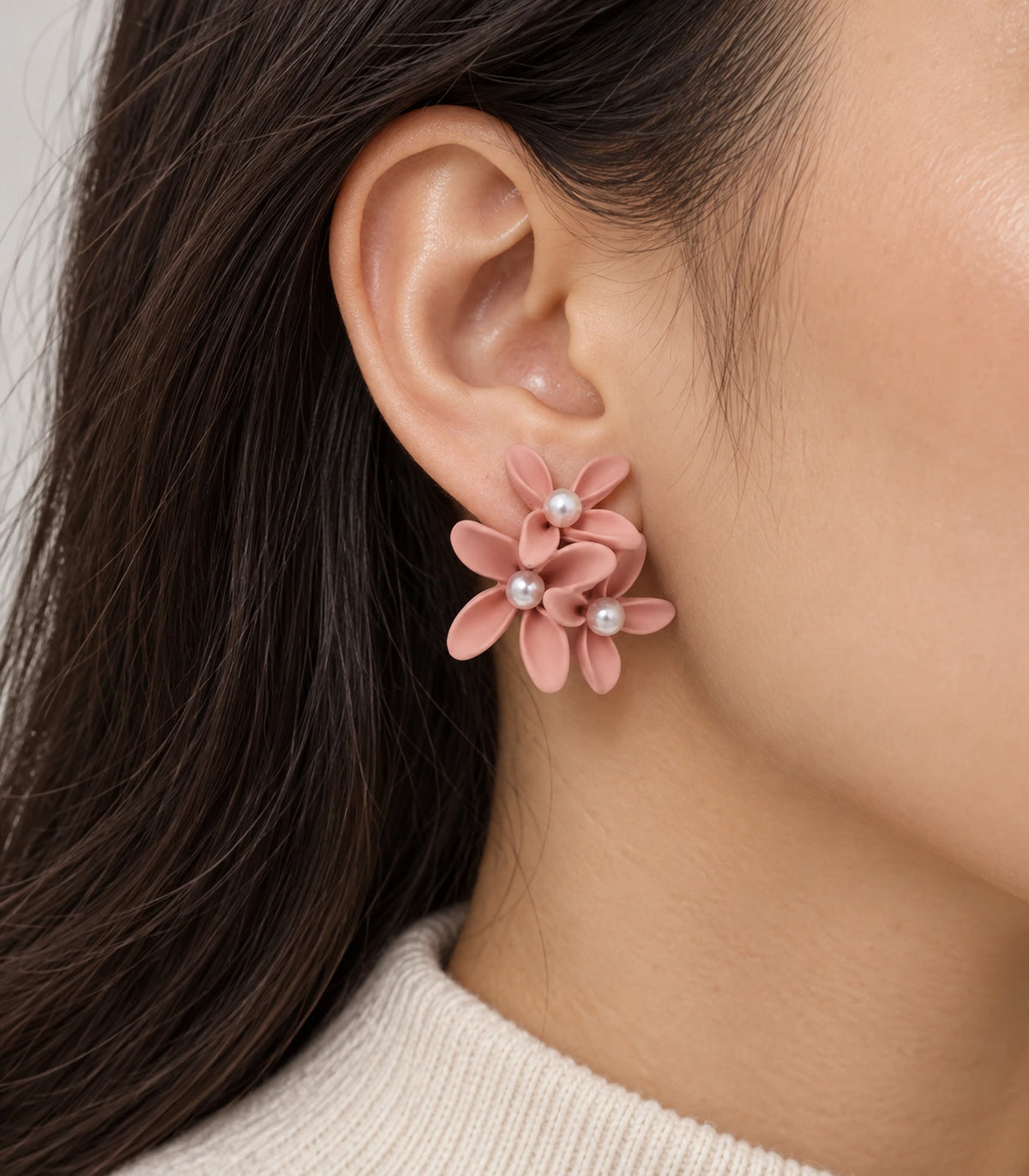 JIMIKI Blush Pink cascading floral cluster stud earrings, worn on the ear with the floral cluster visible #color_blush pink