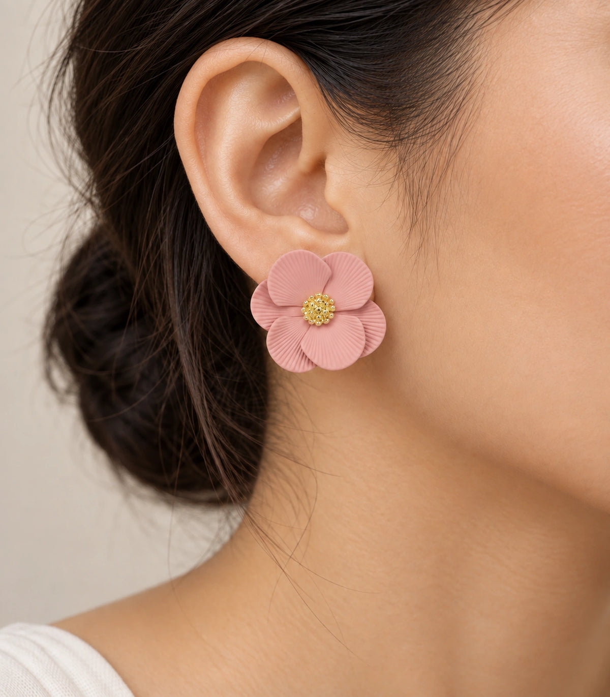 JIMIKI Blush Pink ribbed flower stud earrings, worn closeup of ribbed petals and gold-tone centre #color_blush pink