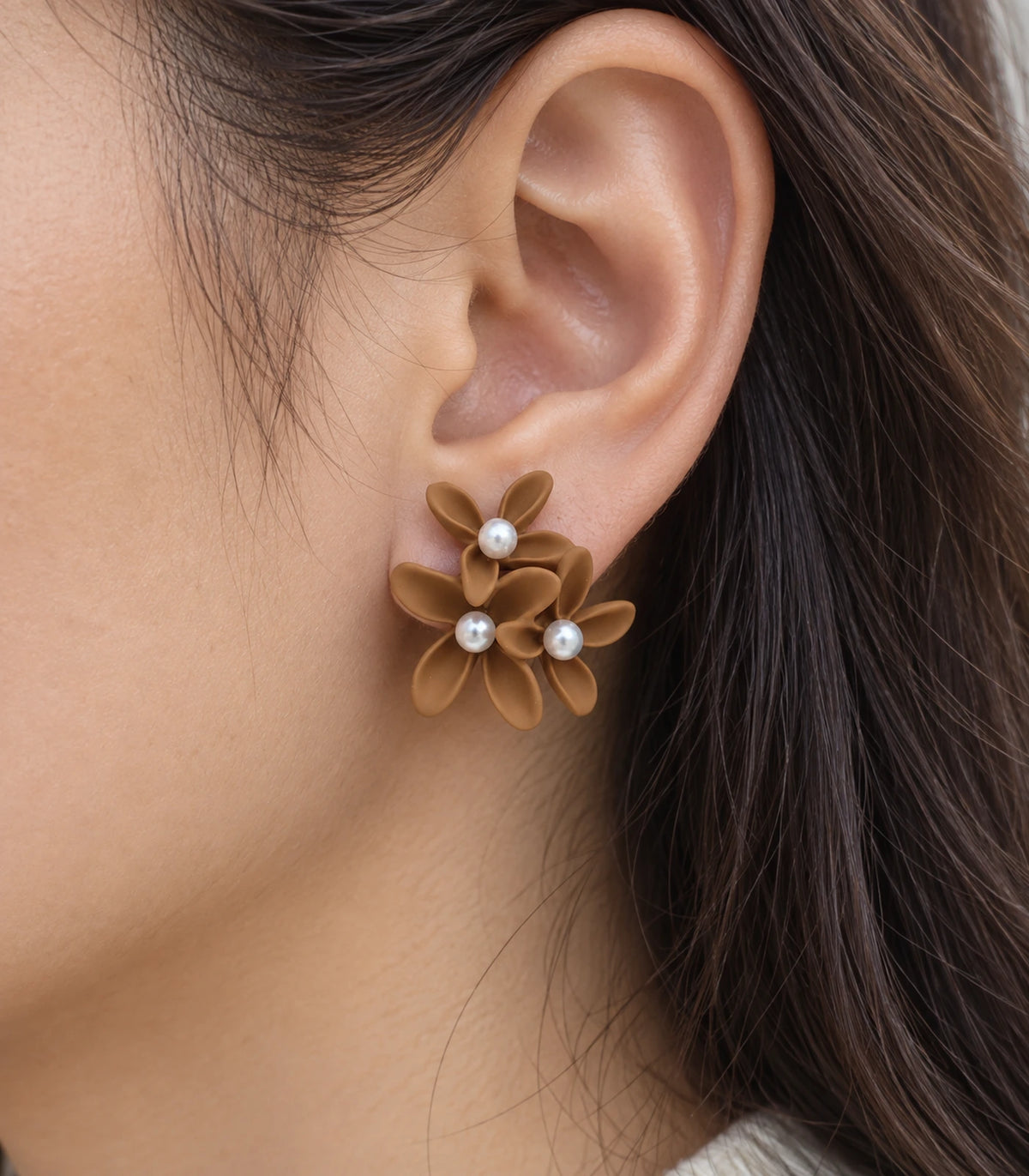 JIMIKI Camel cascading floral cluster stud earrings, close-up of the three pearl-like centres and curved petals #color_camel