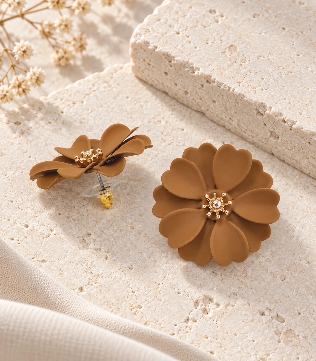 JIMIKI Camel Layered Daisy Stud Earrings - pair in styled flatlay #color_camel