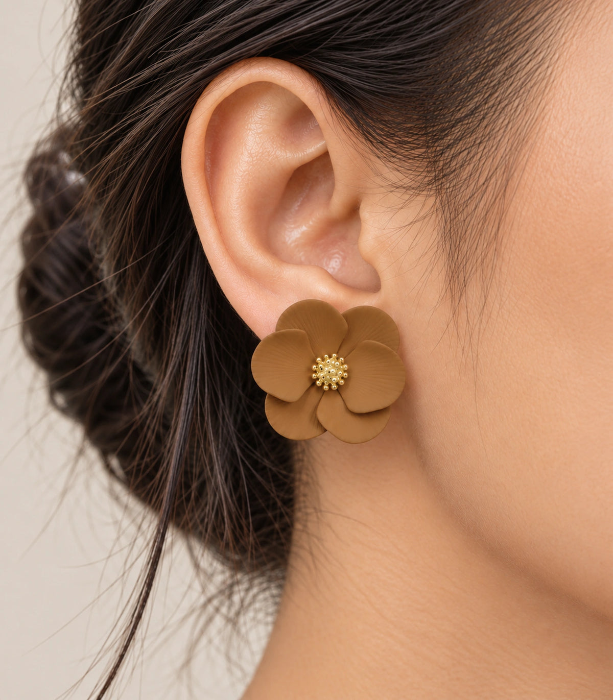 JIMIKI Camel ribbed flower stud earrings, worn closeup of ribbed petals and gold-tone centre #color_camel
