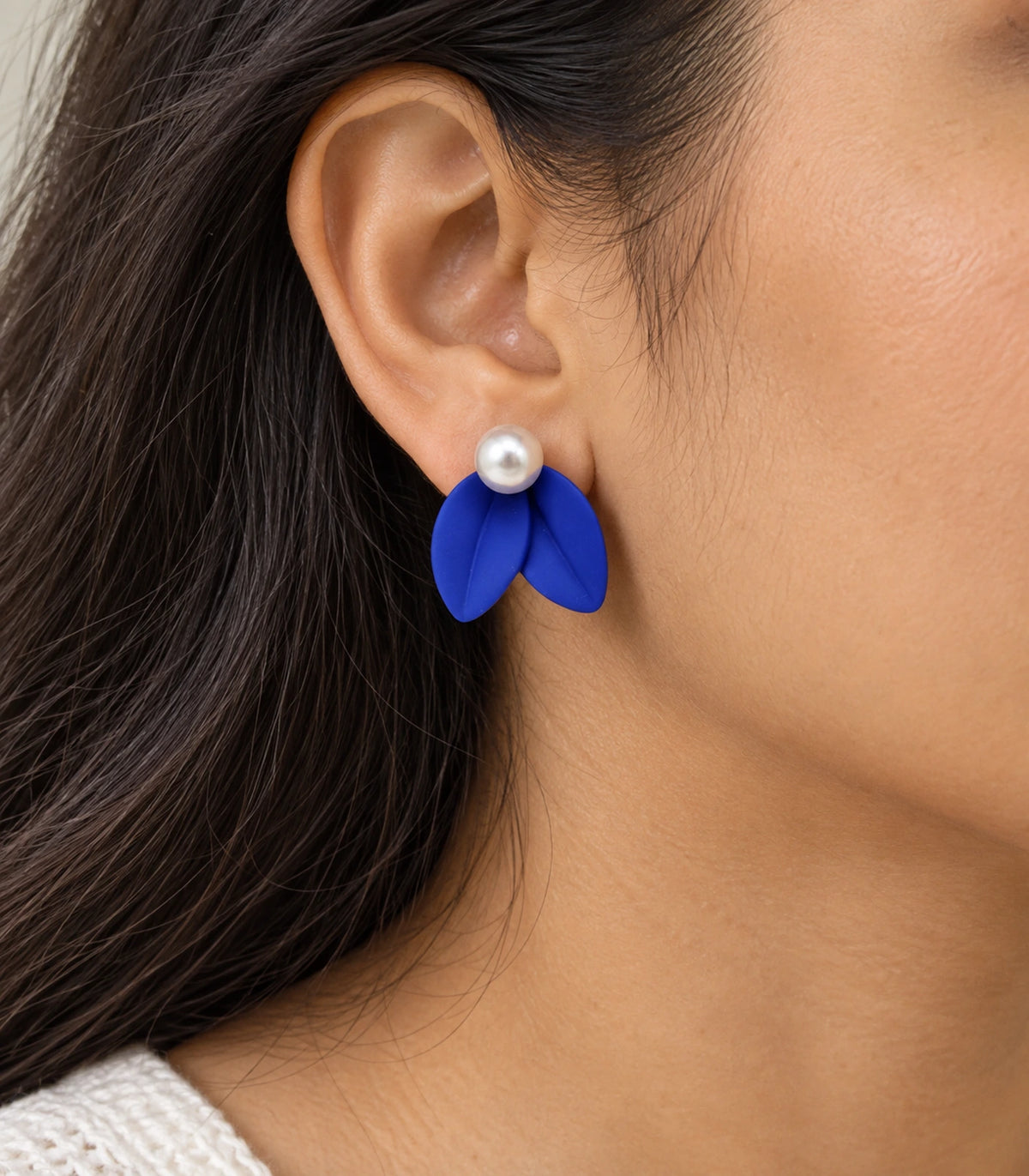 JIMIKI Double Leaf Pearl Stud Earrings in Cobalt Blue — close-up of the earring worn on the ear #color_cobalt blue