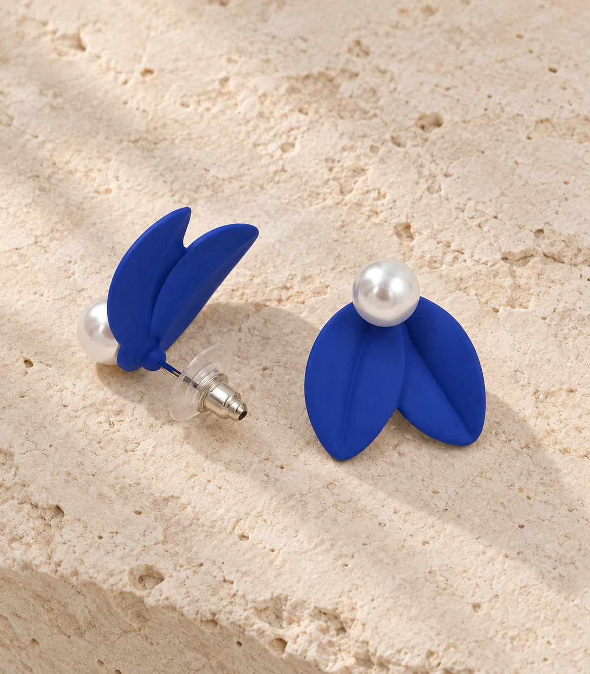 JIMIKI Double Leaf Pearl Stud Earrings in Cobalt Blue — pair in a styled flat lay #color_cobalt blue