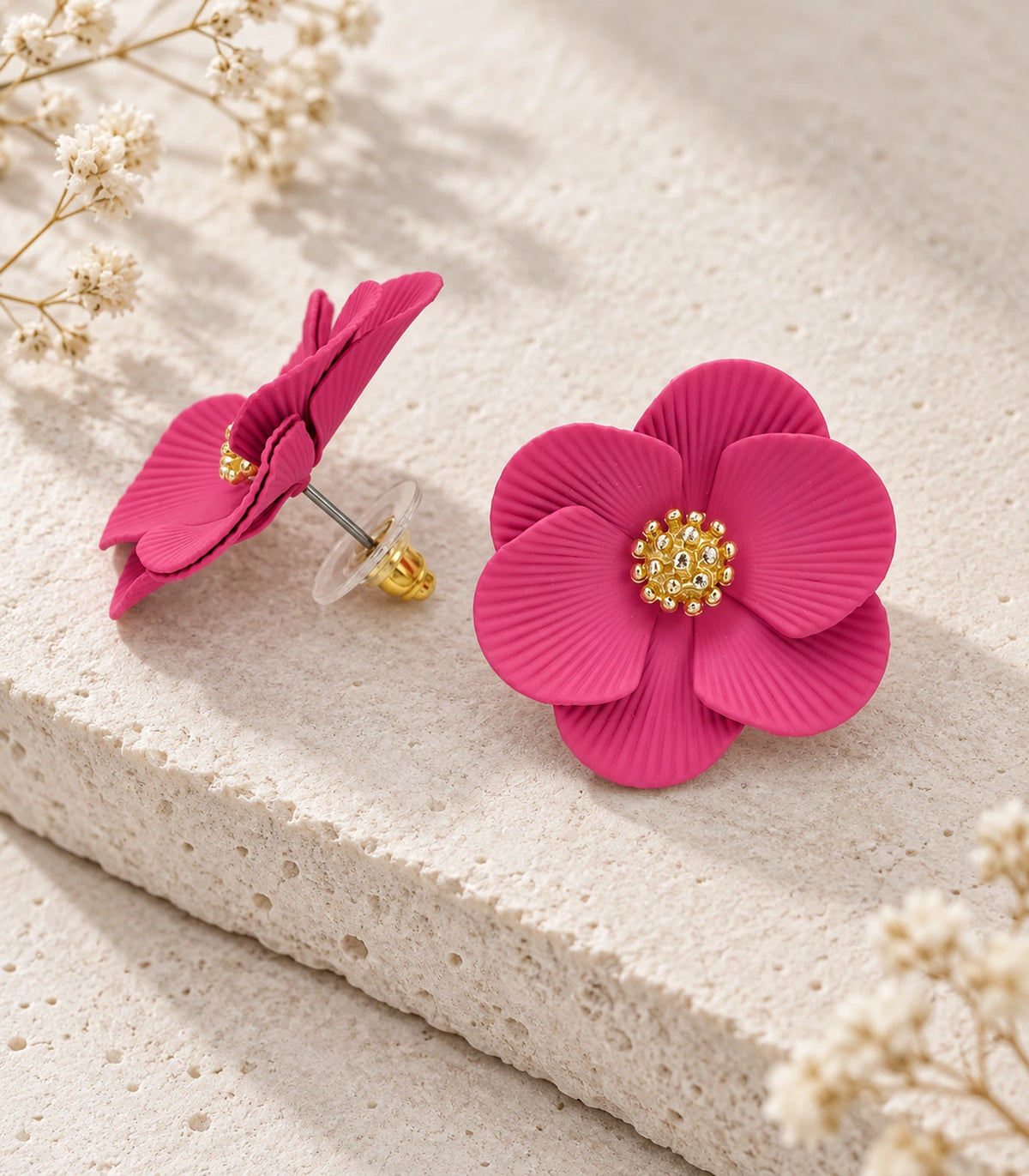 JIMIKI Fuchsia ribbed flower stud earrings, pair arranged in an editorial flat lay #color_fuchsia