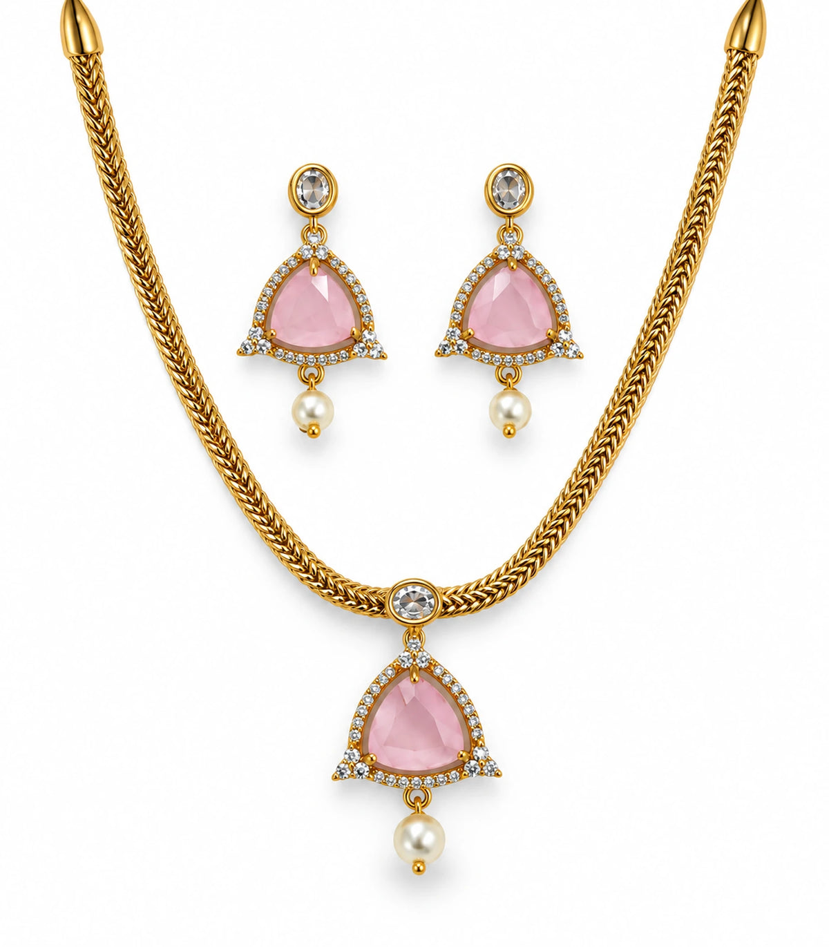 Gold-tone blush pink necklace and two matching pearl-drop earrings on white