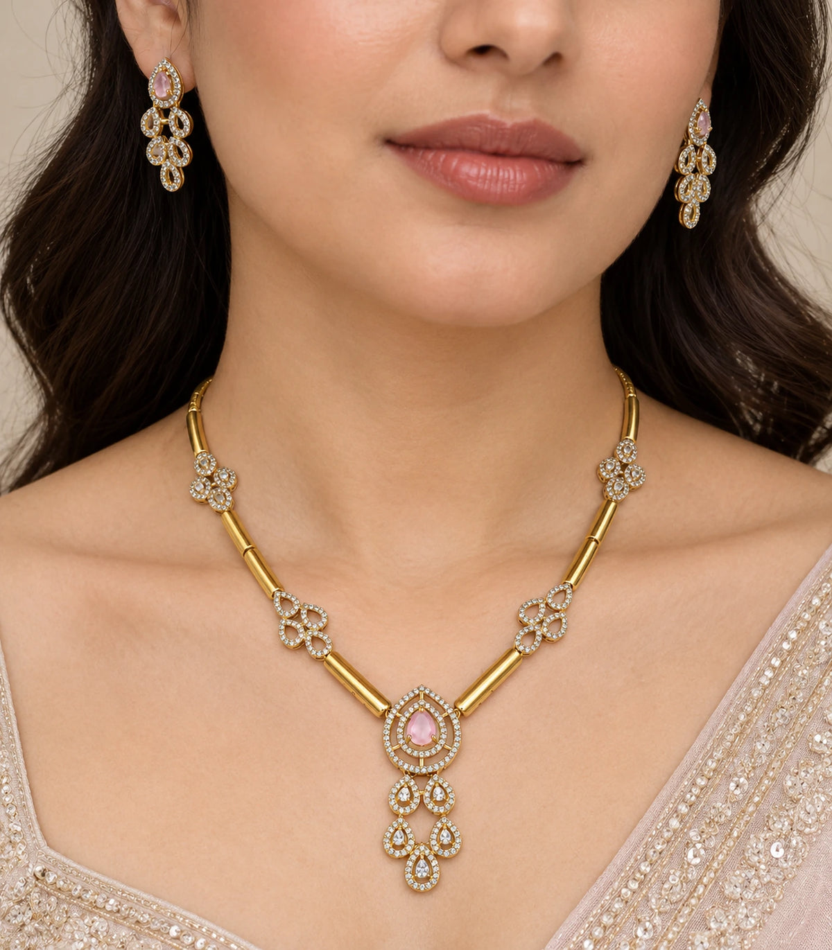 Close view of the blush teardrop pendant and matching earrings worn naturally
