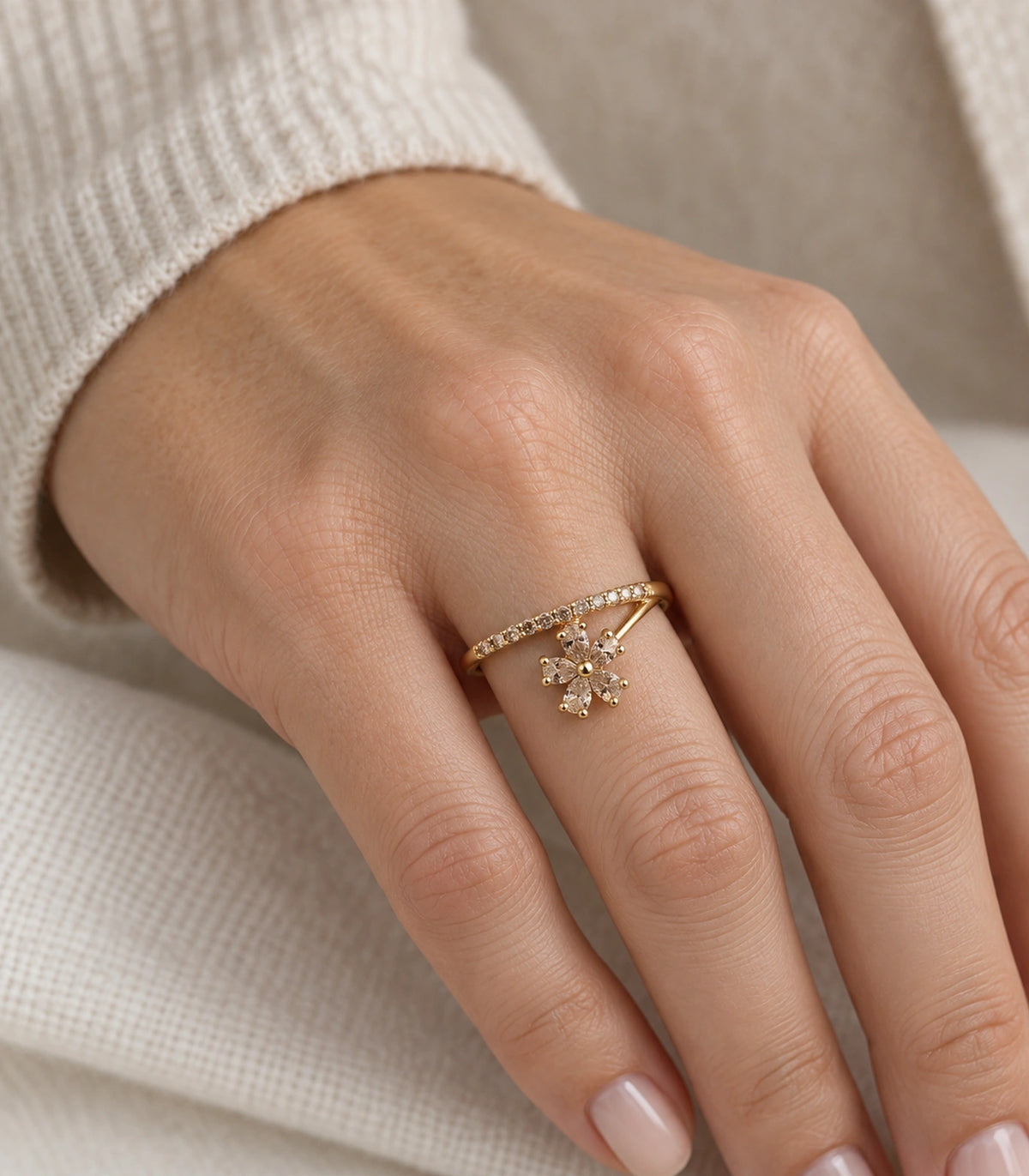 Gold Champagne Crystal Flower Sweep Ring — ring worn on hand with cream knit sleeve