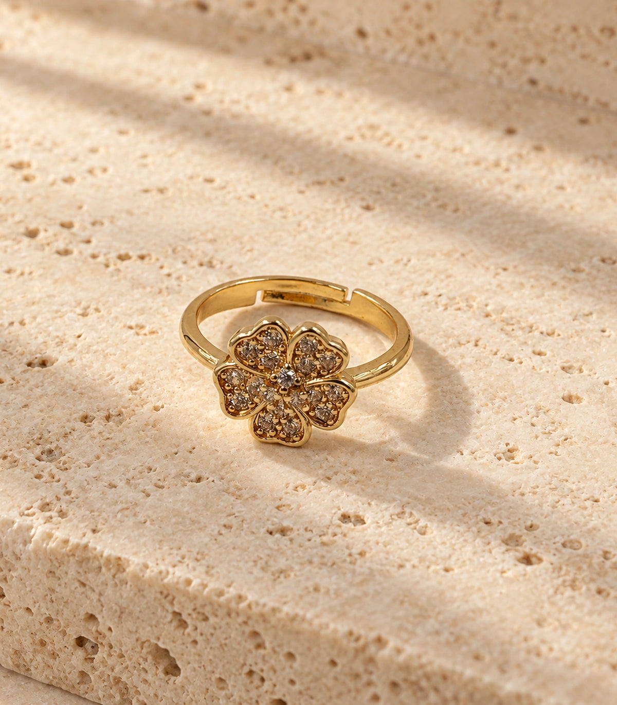 Gold-tone champagne crystal flower ring in a styled flat lay