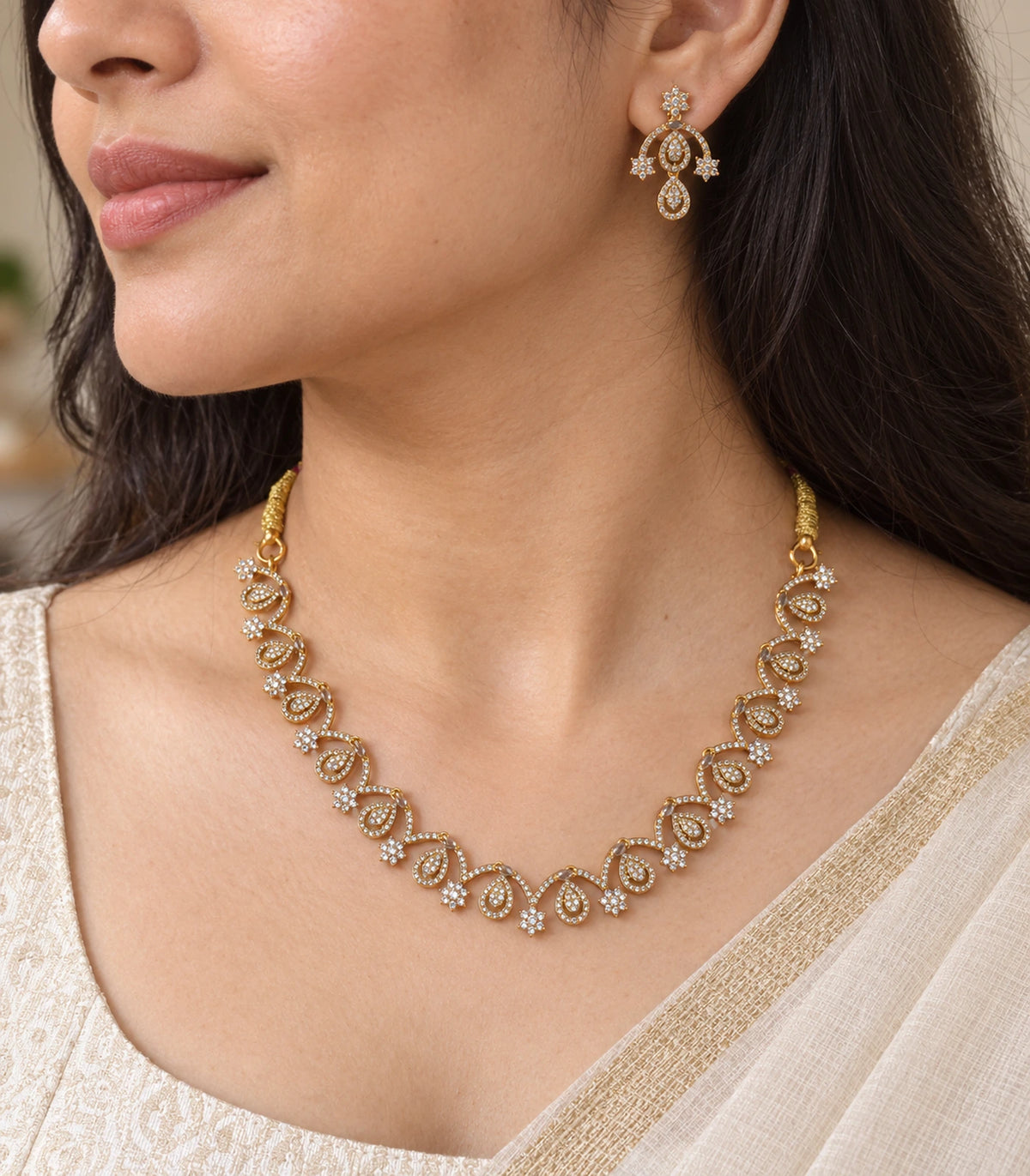 Close view of the Gold Clear Loop Crystal Necklace Set and matching earring worn