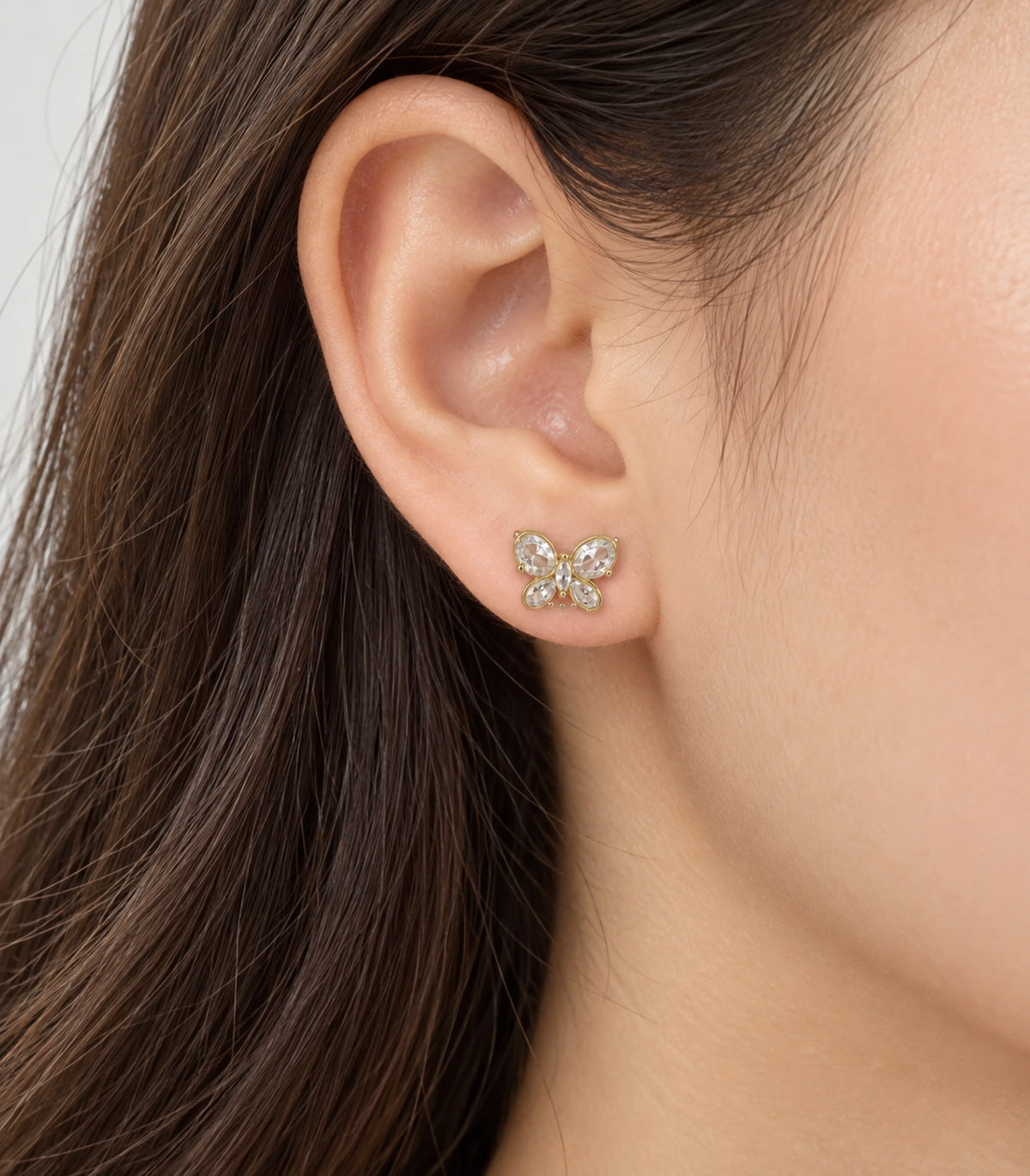 JIMIKI Gold Crystal Butterfly Stud Earrings — worn styling view #color_gold-tone