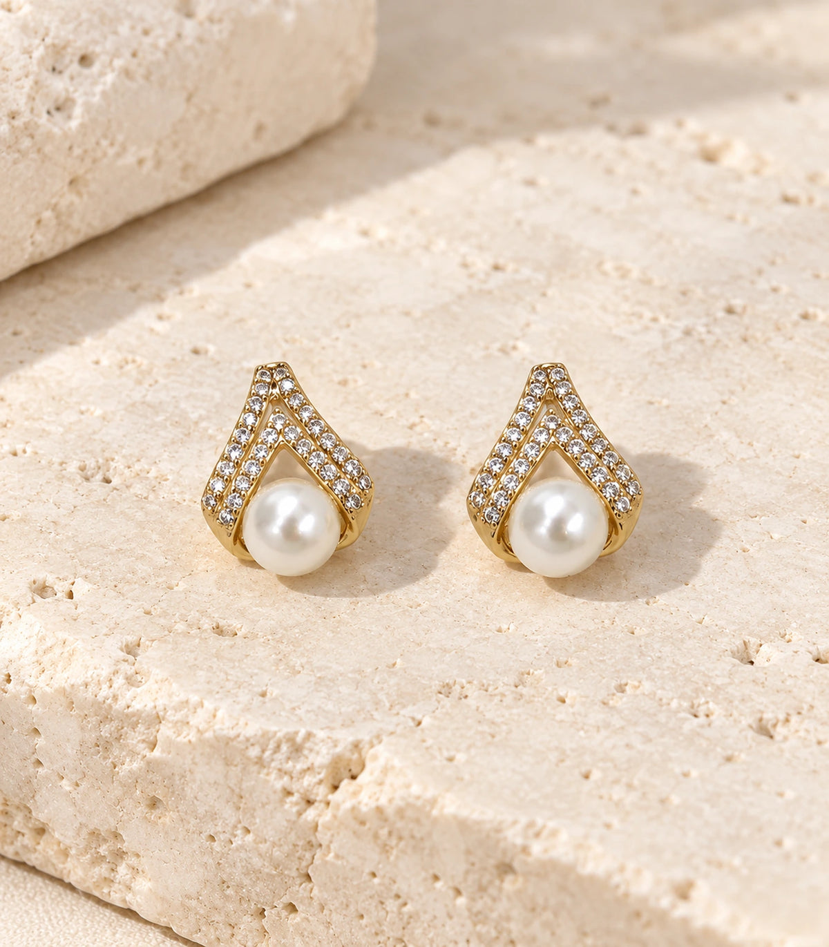 JIMIKI Gold Crystal Teardrop Pearl Earrings — editorial flat lay #color_gold-tone