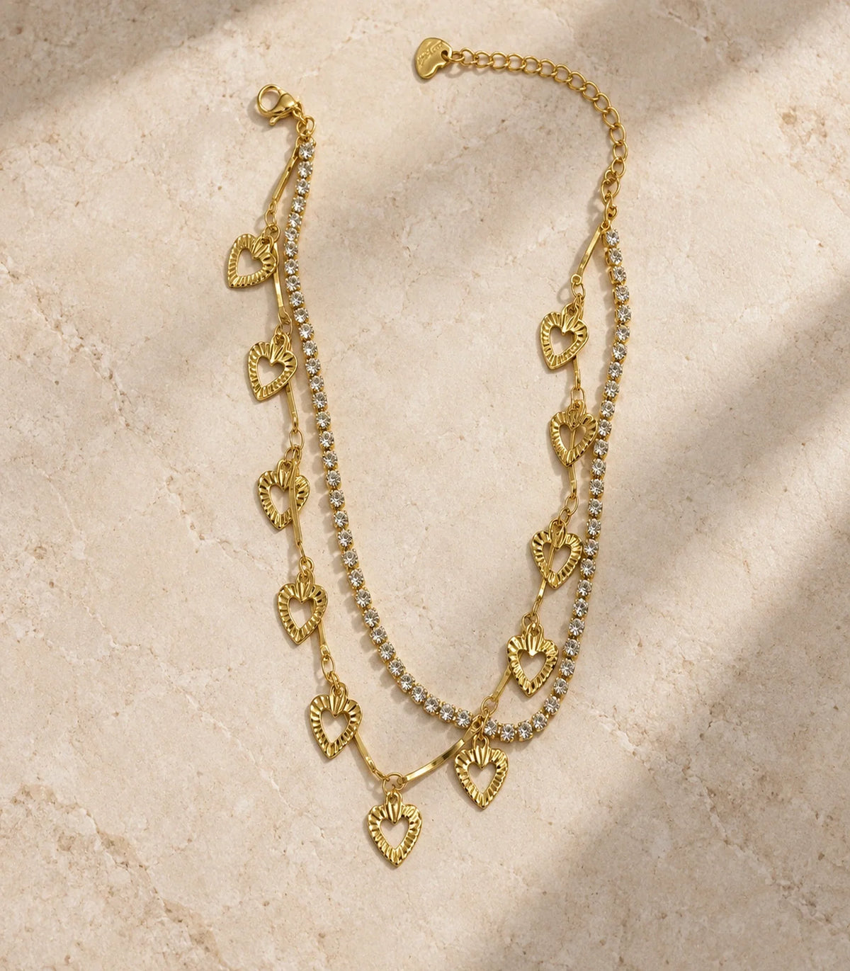 Gold Crystal Tennis Heart Charm Layered Anklet — editorial flatlay