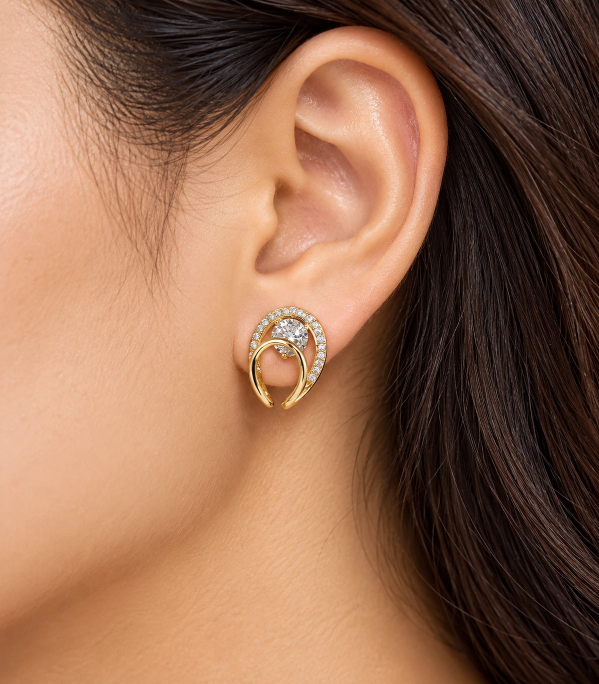 Gold-tone double-loop stud earring in an editorial worn view