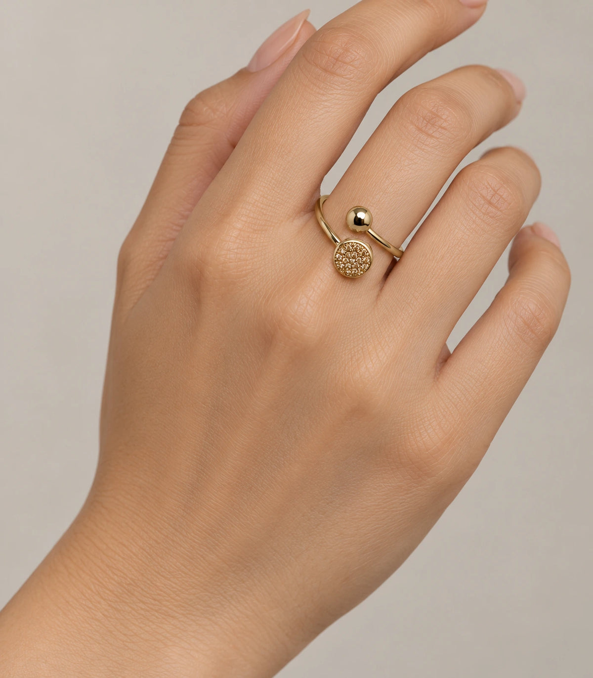 Gold Dual Disc Crystal Open Ring worn on a finger