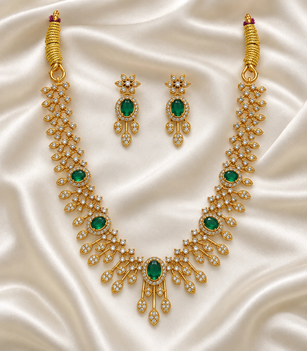 Complete green and gold-tone necklace set arranged on satin