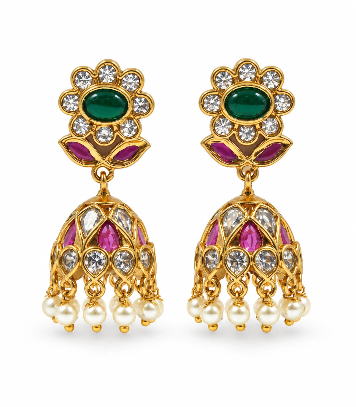 Matching pair of gold-tone emerald-green and magenta floral jhumka earrings with clear accents and white pearl fringe on white